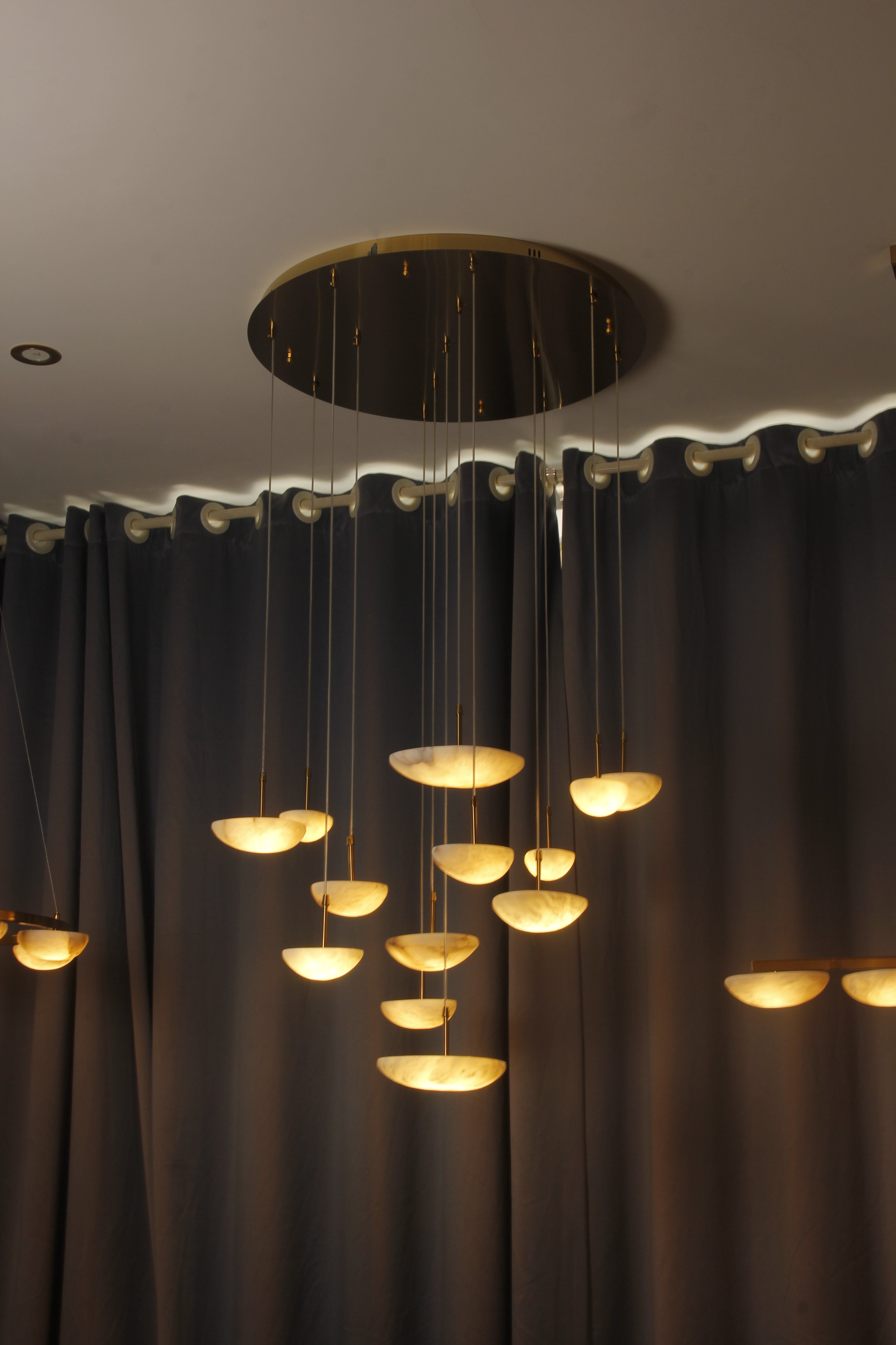 VORELLI® Alba Marble Staircase Pendant Chandelier in a luxury interior with suspended stone elements along a staircase void