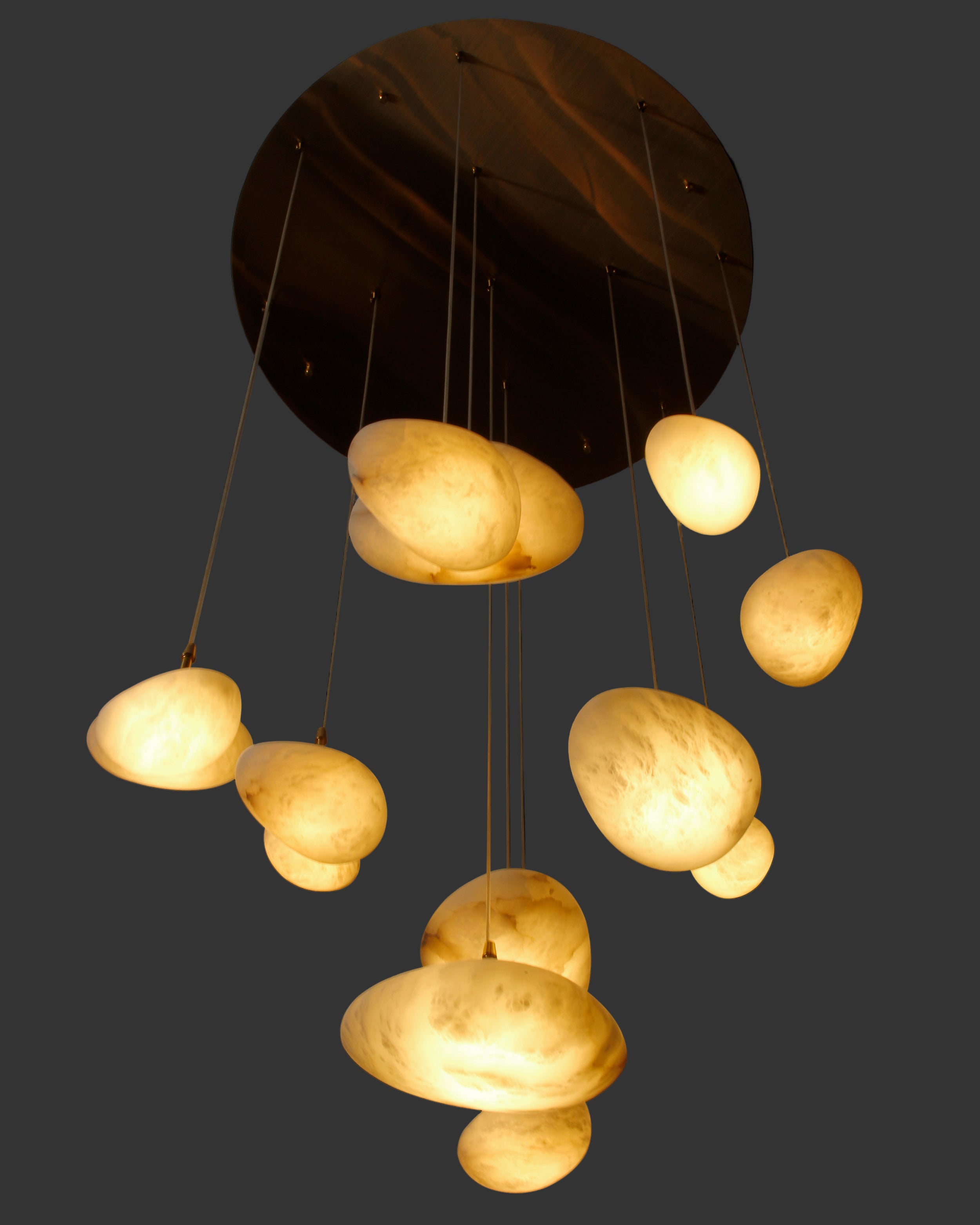 Close-up of VORELLI® Alba Staircase Chandelier showcasing layered stone pendant drops in soft ambient light