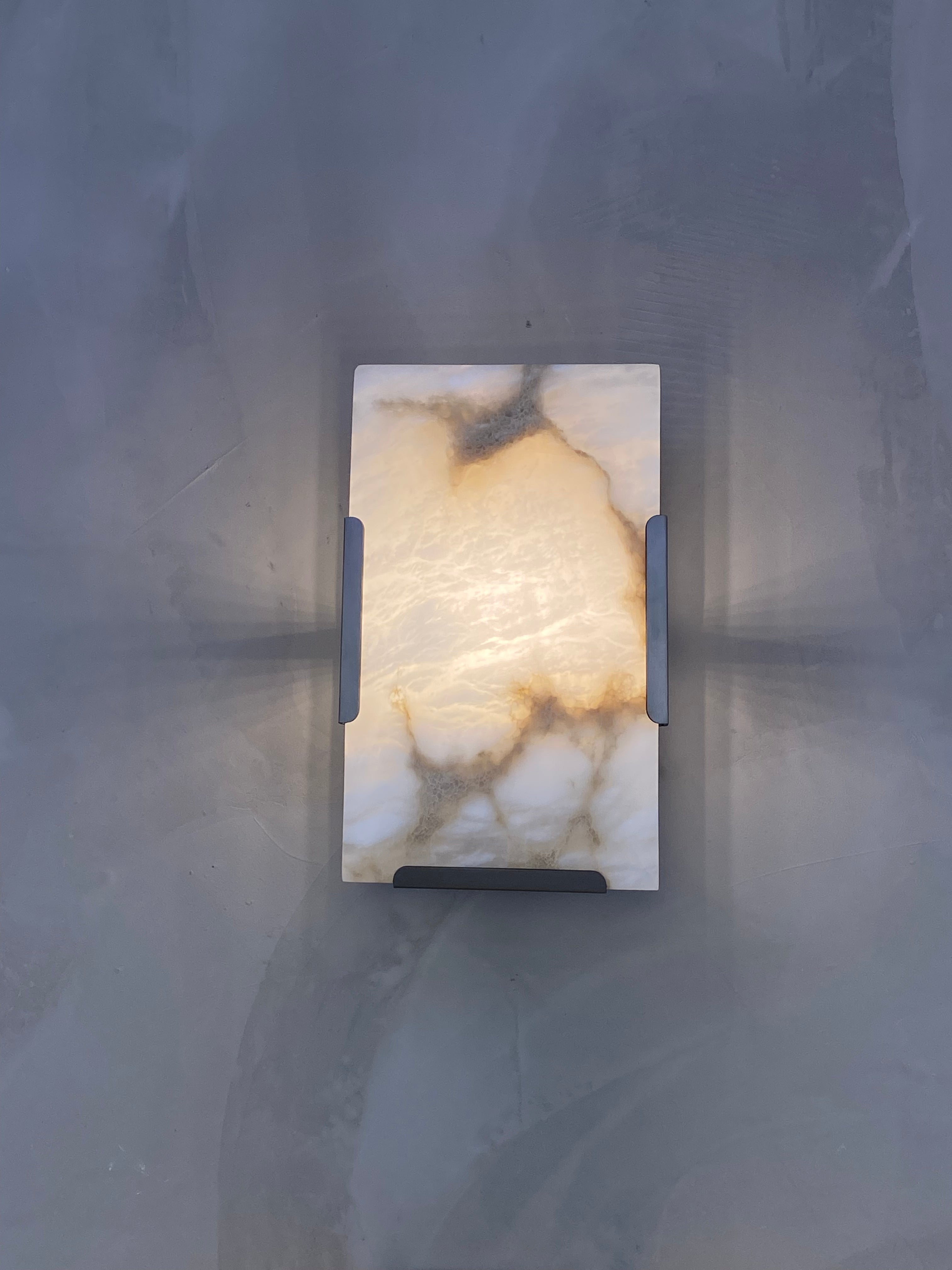 Front view of the Angel Marble Wall Light showing its rectangular form and clean marble pattern under cool ambient light.
