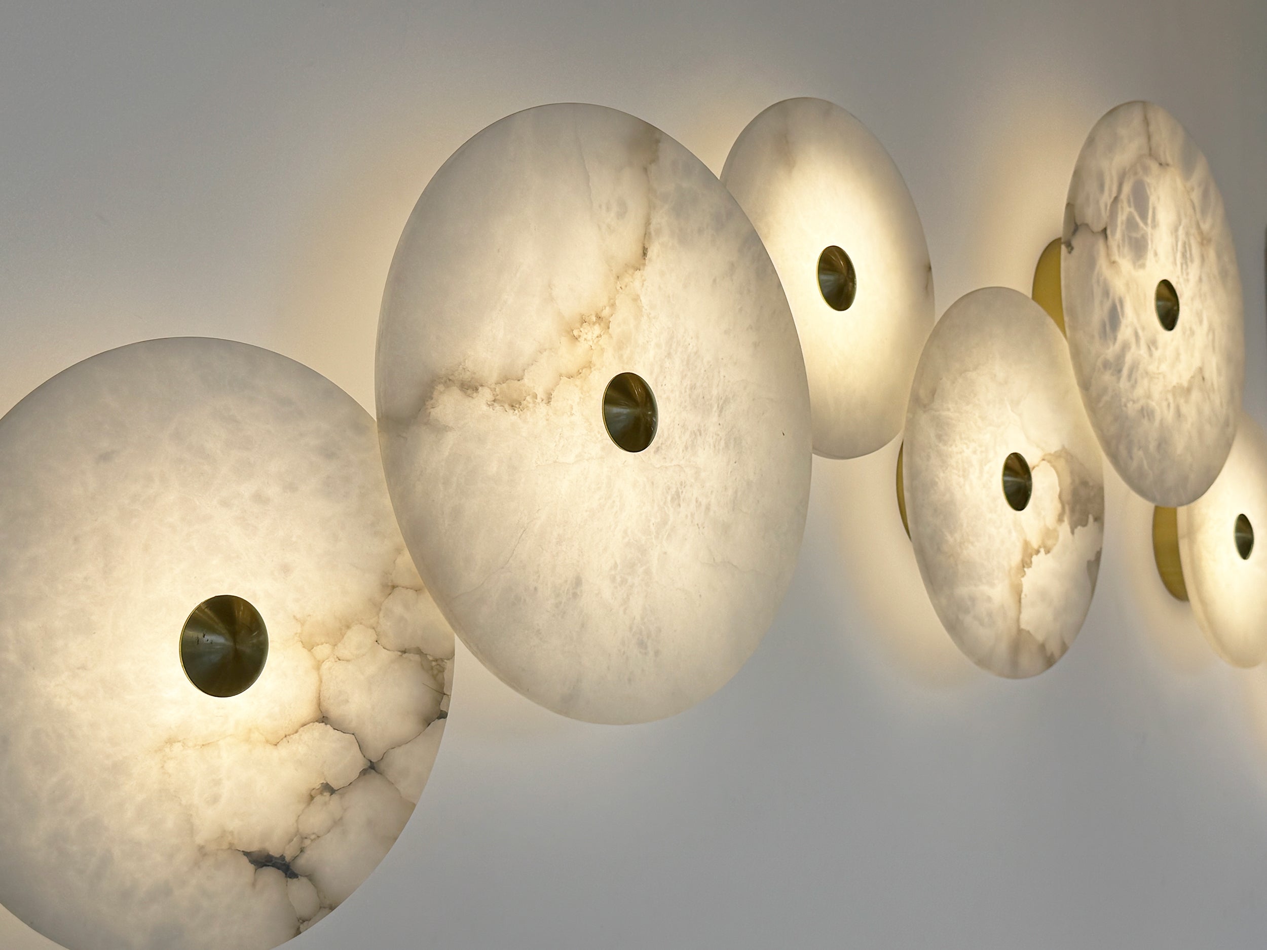 Series of Aria lights displayed in a continuous line against a textured grey wall.