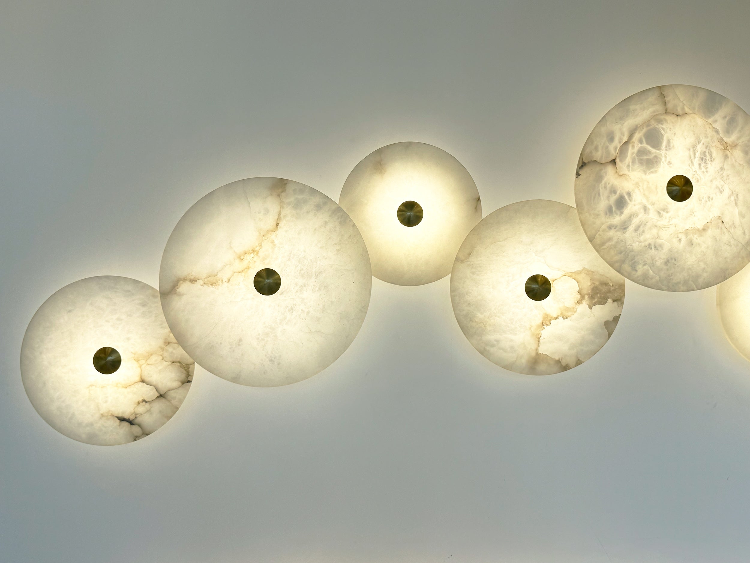 Warm chandelier glow enhancing a stylish blue-toned modern interior.