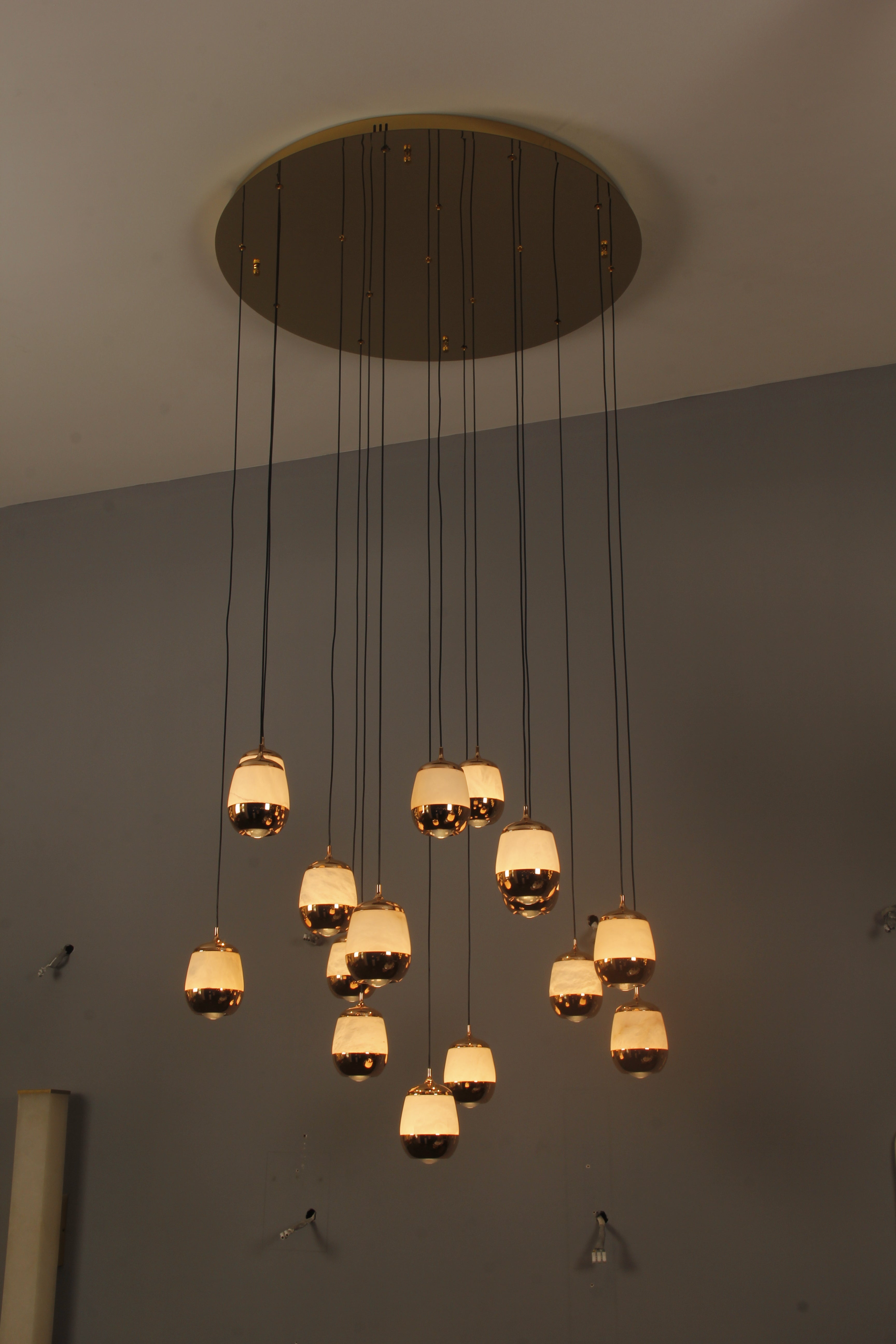 Full-height view of the Caldera Marble Pendant Staircase Chandelier captured from below, showcasing dramatic drop lengths.