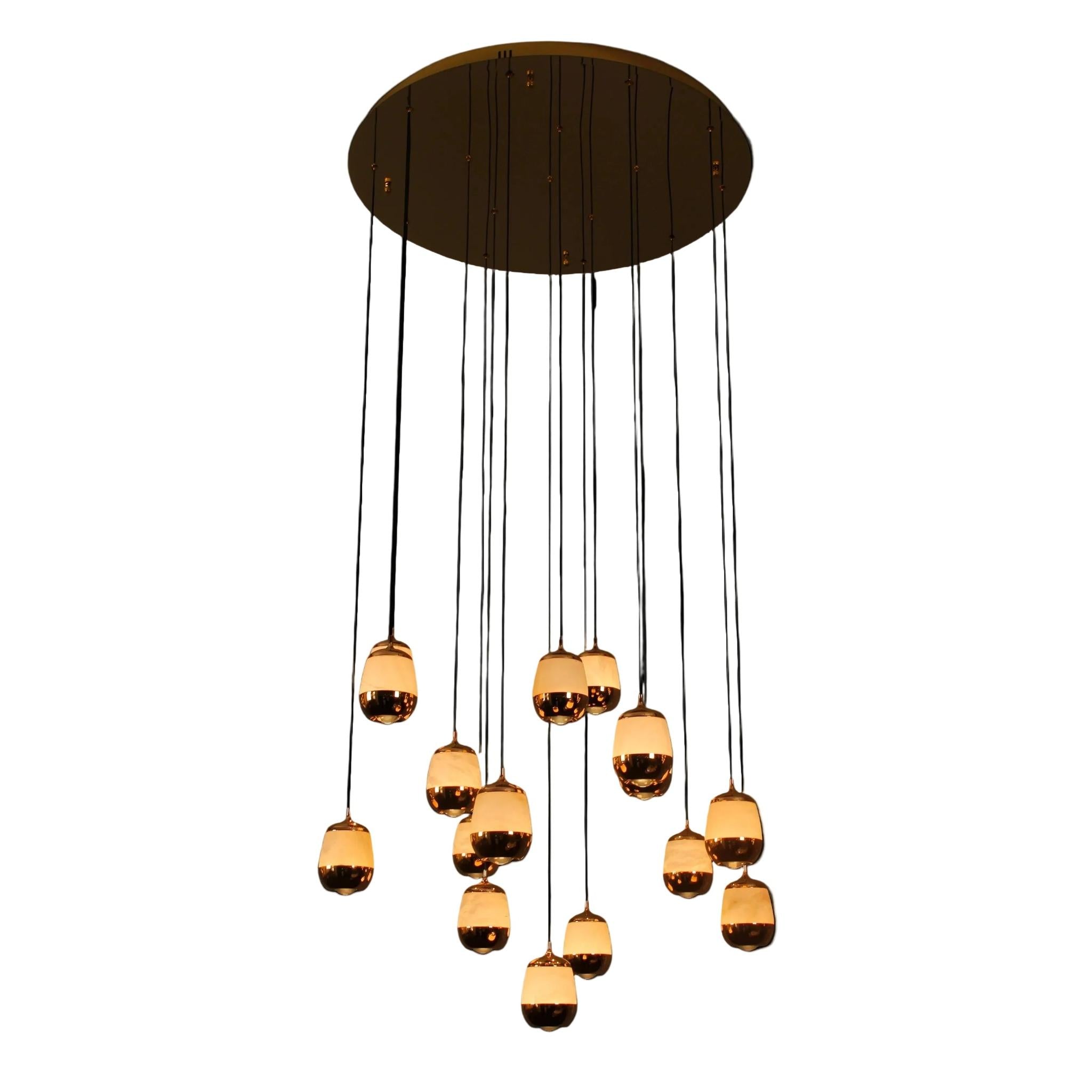 Caldera Marble Pendant Staircase Chandelier featuring cascading illuminated marble drops suspended from a circular ceiling plate.