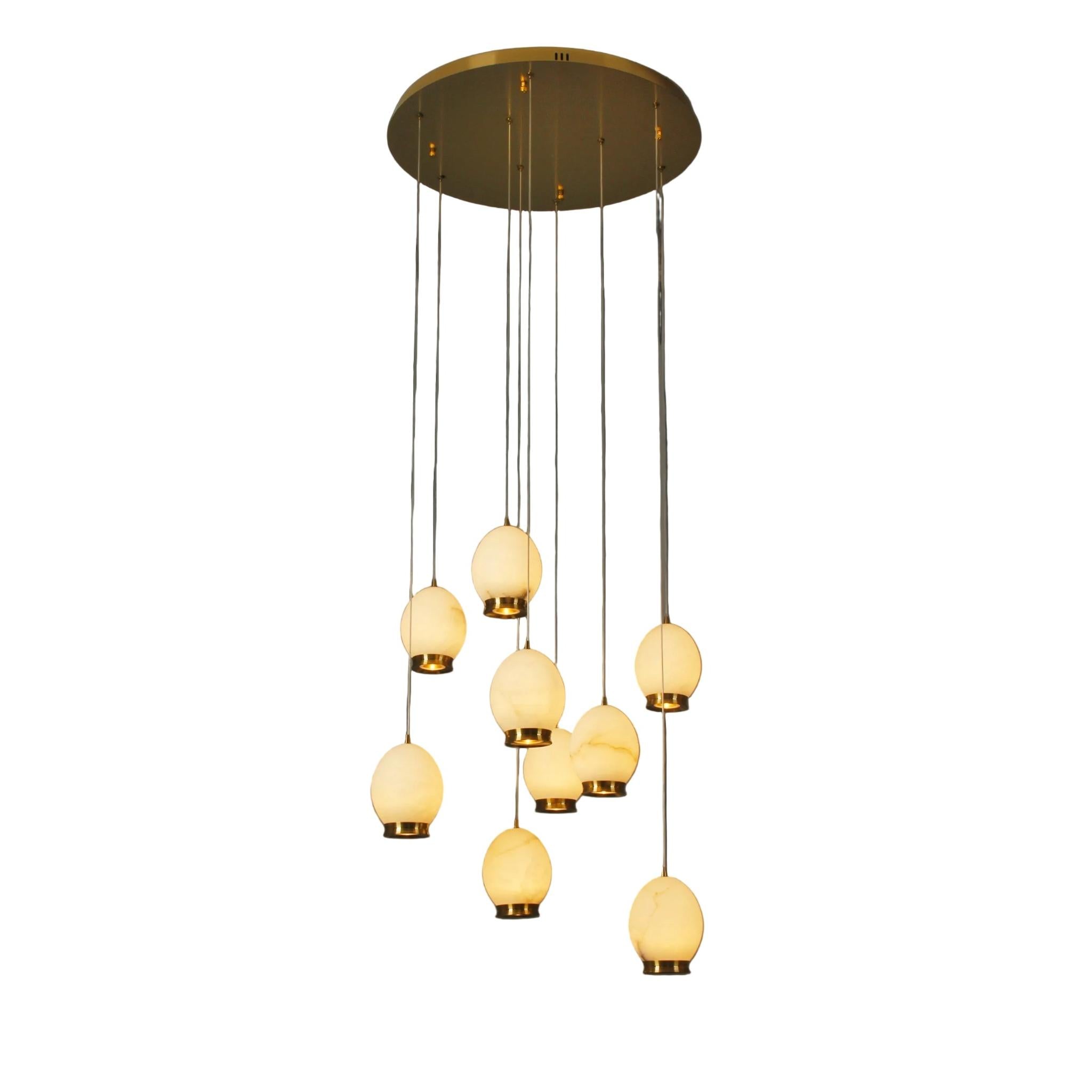 Caledonia Marble Staircase Chandelier with cascading illuminated marble globes suspended from a circular ceiling plate.