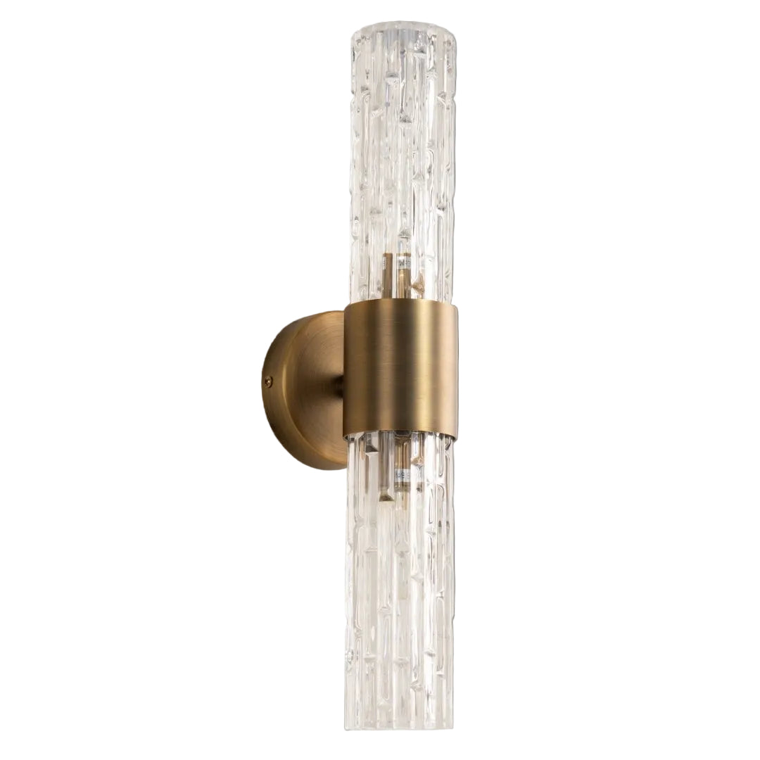 Wall-mounted light fixture with gold finish and clear glass on a gray background