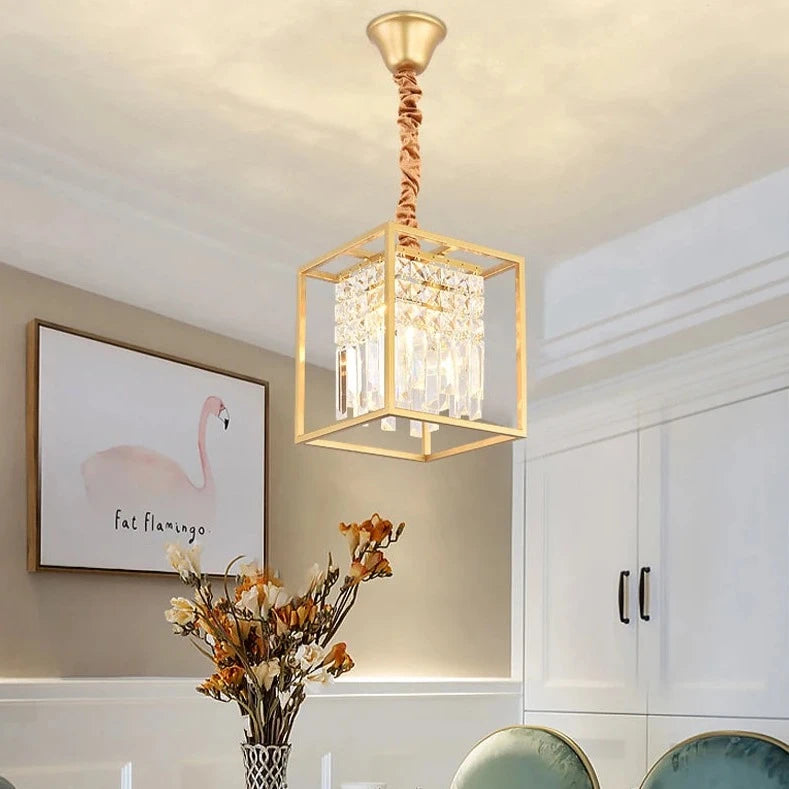 Gold Maddison pendant light featuring cube frame and internal crystal bars