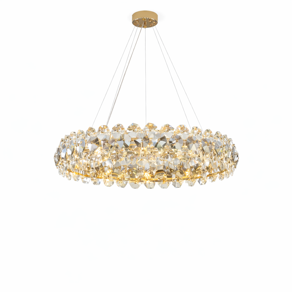 Luxury circular crystal chandelier with faceted geometric crystal elements, warm integrated illumination, slim suspension cables, and a polished gold ceiling canopy on a pure white background.