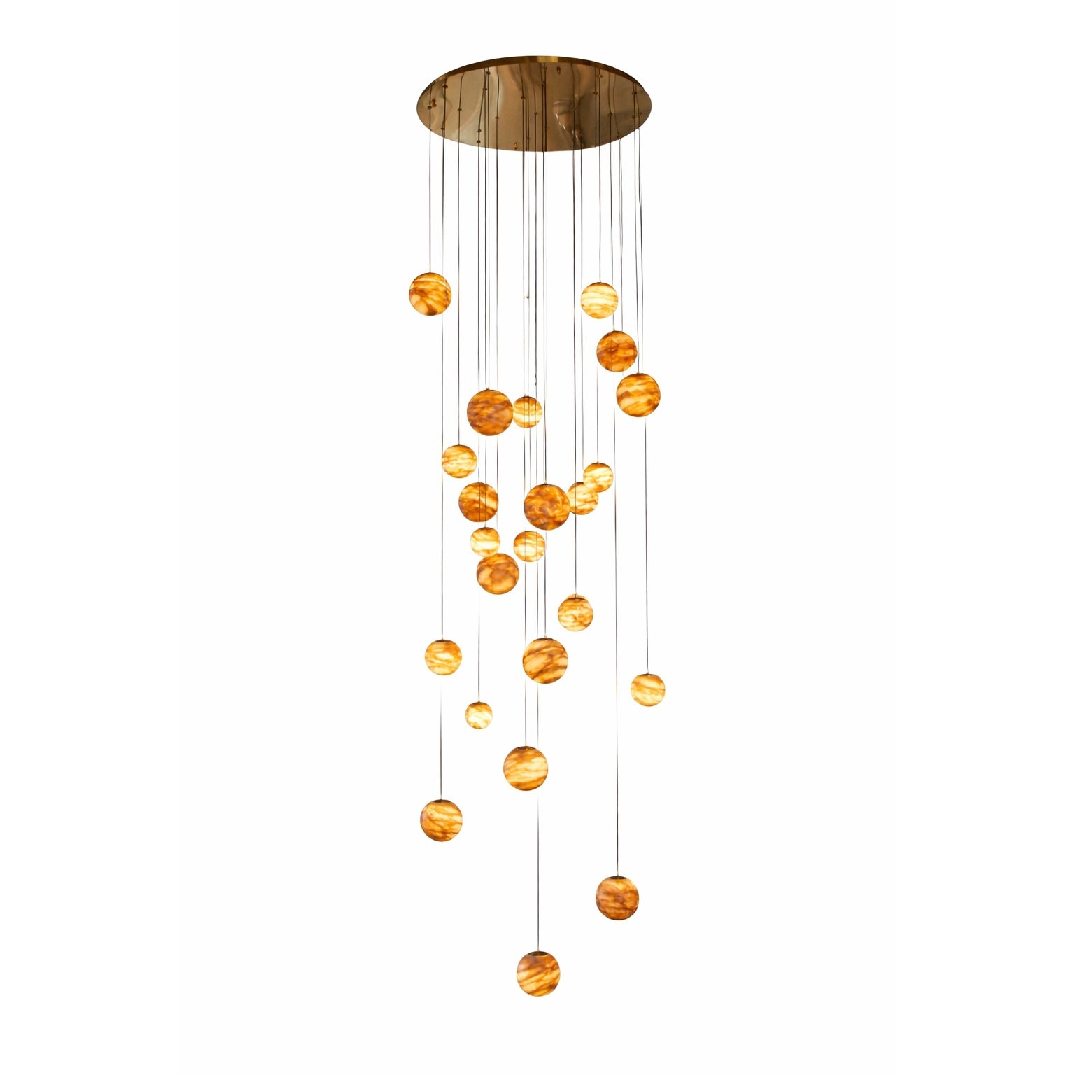 Luxury cascading marble sphere staircase chandelier with multiple illuminated natural stone globes suspended at varying heights from a polished circular ceiling canopy, isolated on pure white background