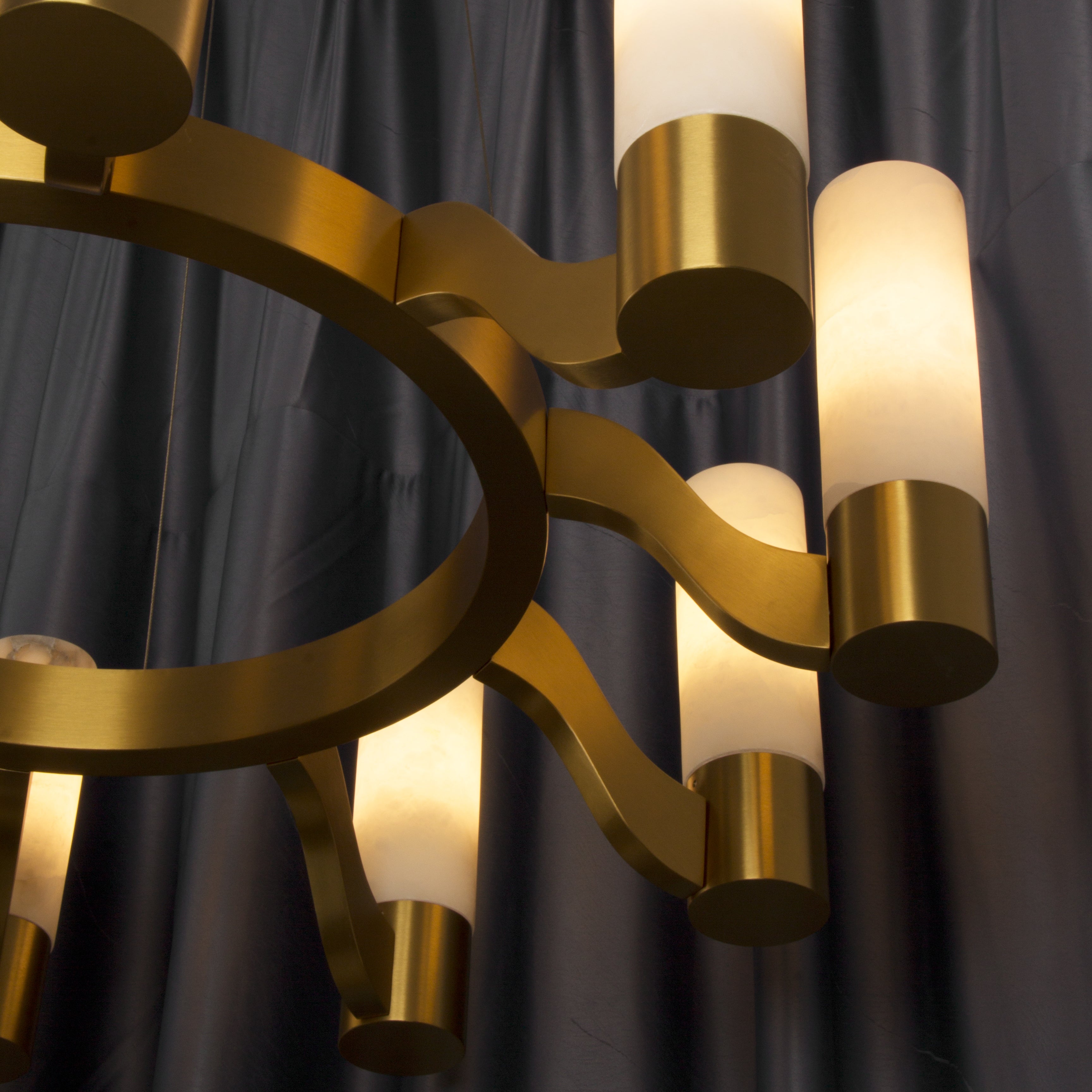 Close-up of VORELLI® Valenza Marble Circular Chandelier with alabaster marble cylindrical shades and gold sculptural ring design.