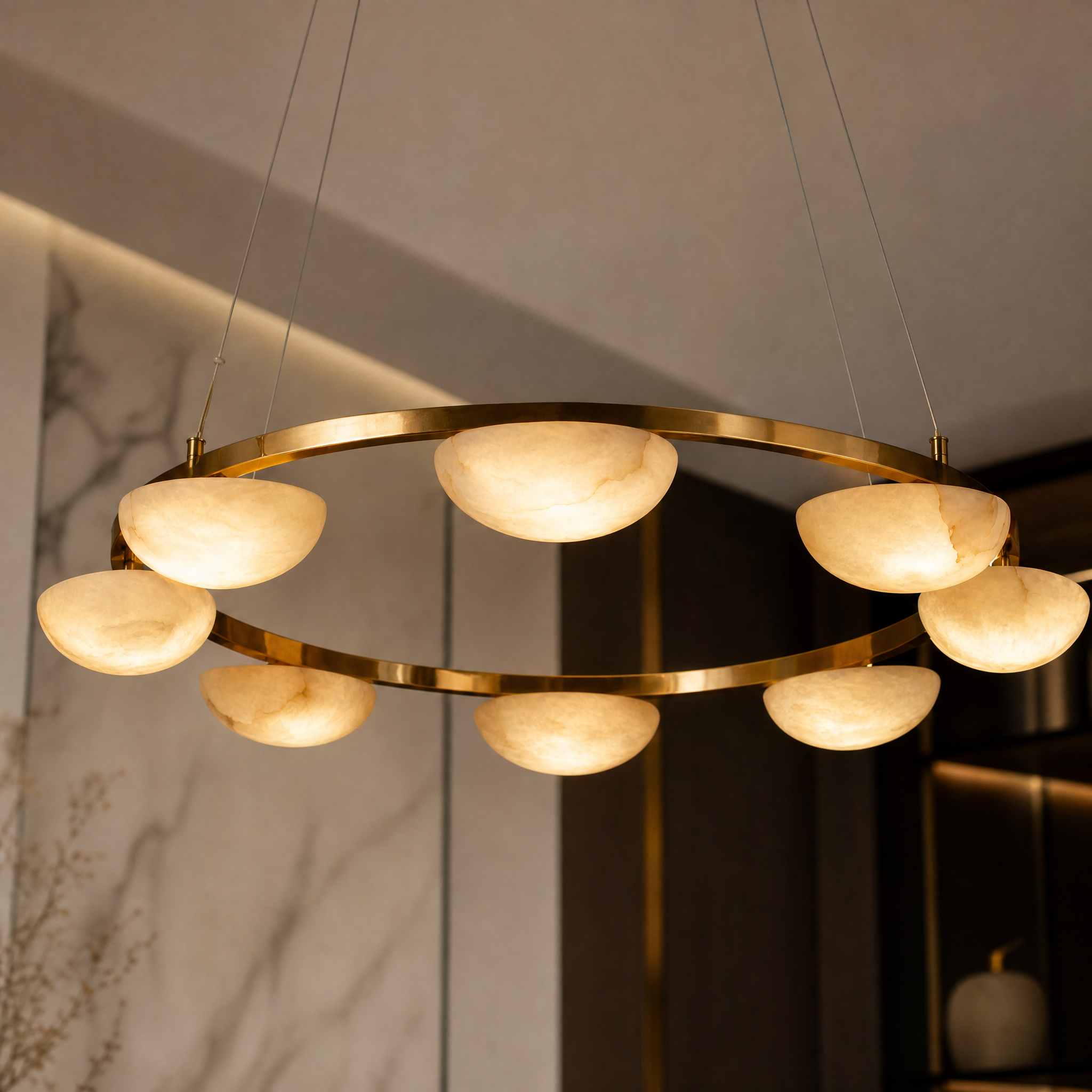 A detailed close-up capturing the smooth finish and quiet luxury of the continuous marble ring on the Alba circular chandelier by VORELLI.