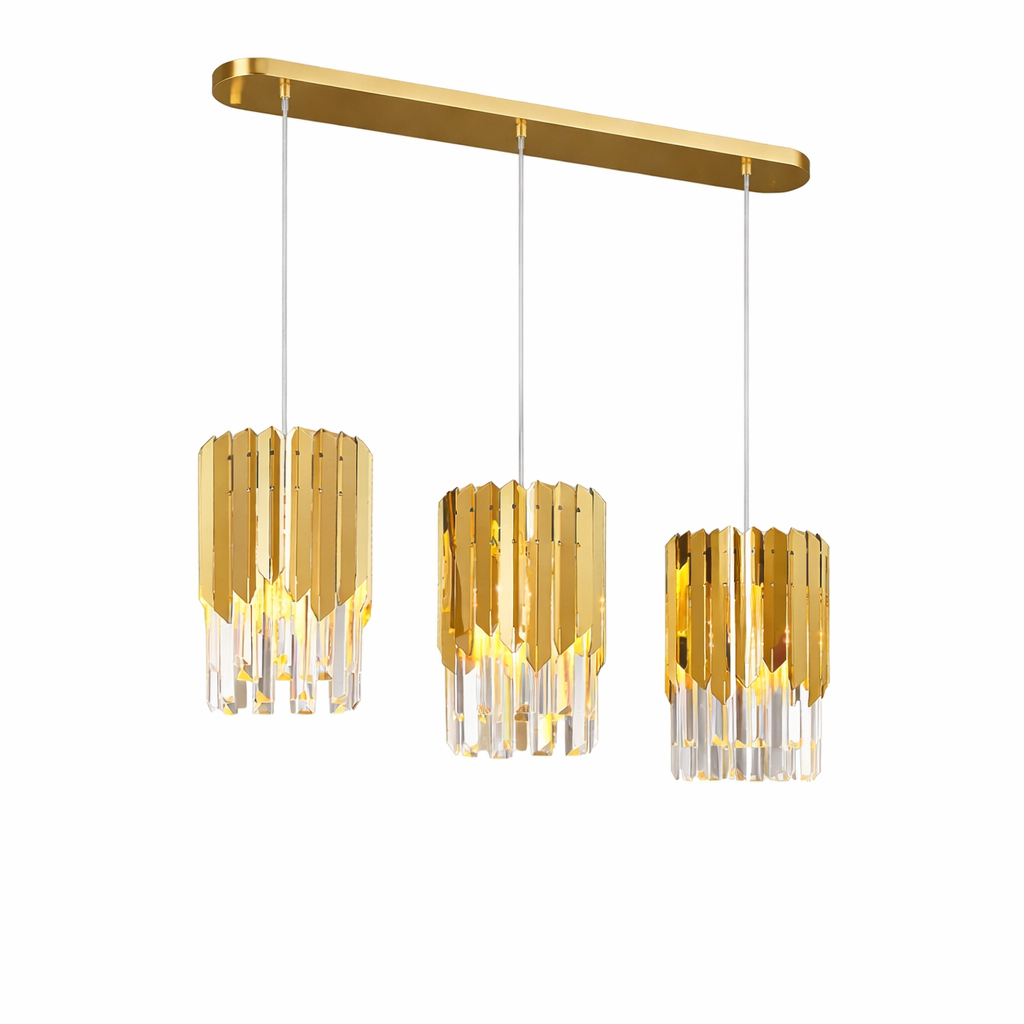 A warm, atmospheric view of the VORELLI Manhattan Rectangular Chandelier II casting a dramatic, shimmering glow across an upscale interior.