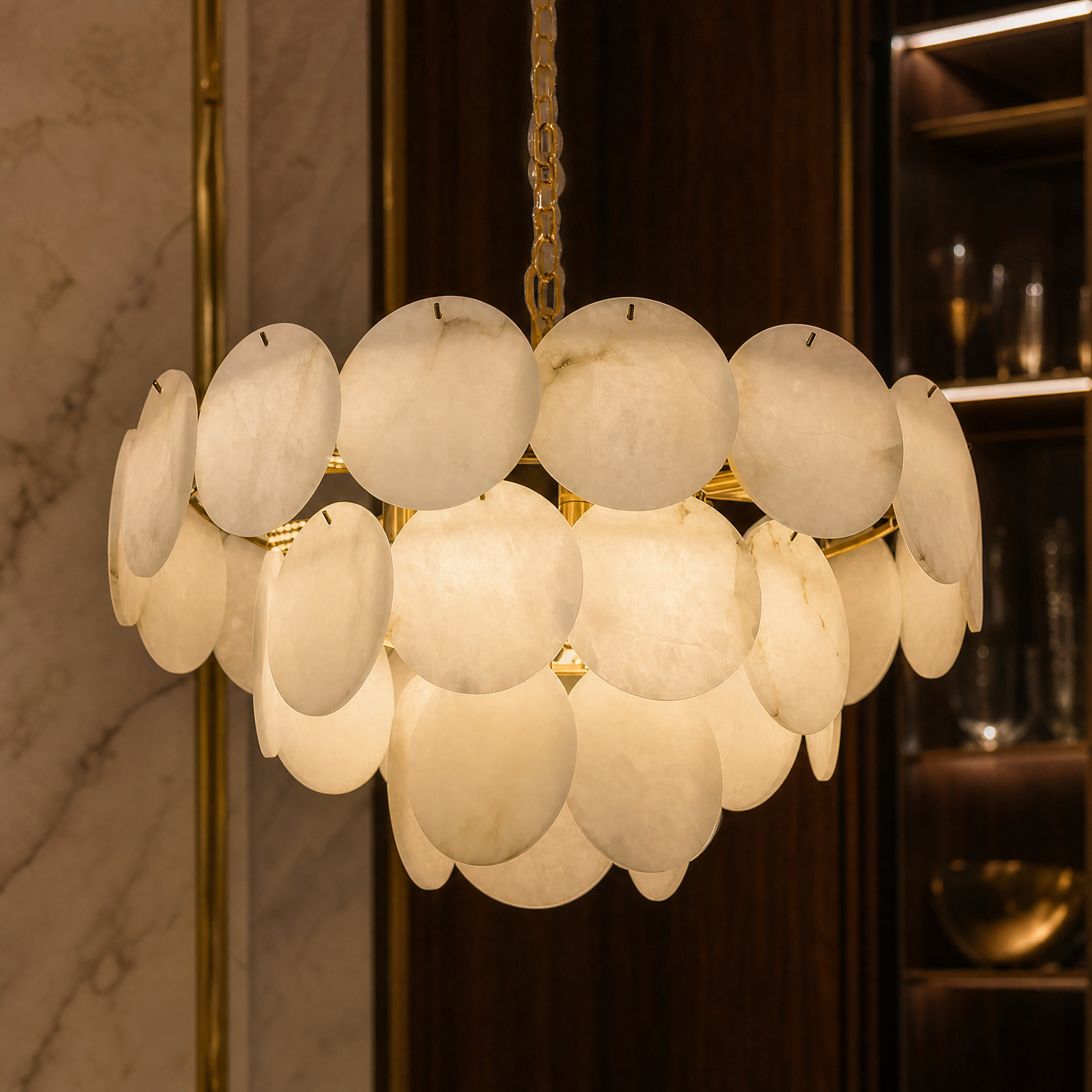 A detailed closeup of the VORELLI Alfonso circular chandelier highlighting the smooth texture and elegant layers of the natural marble discs.