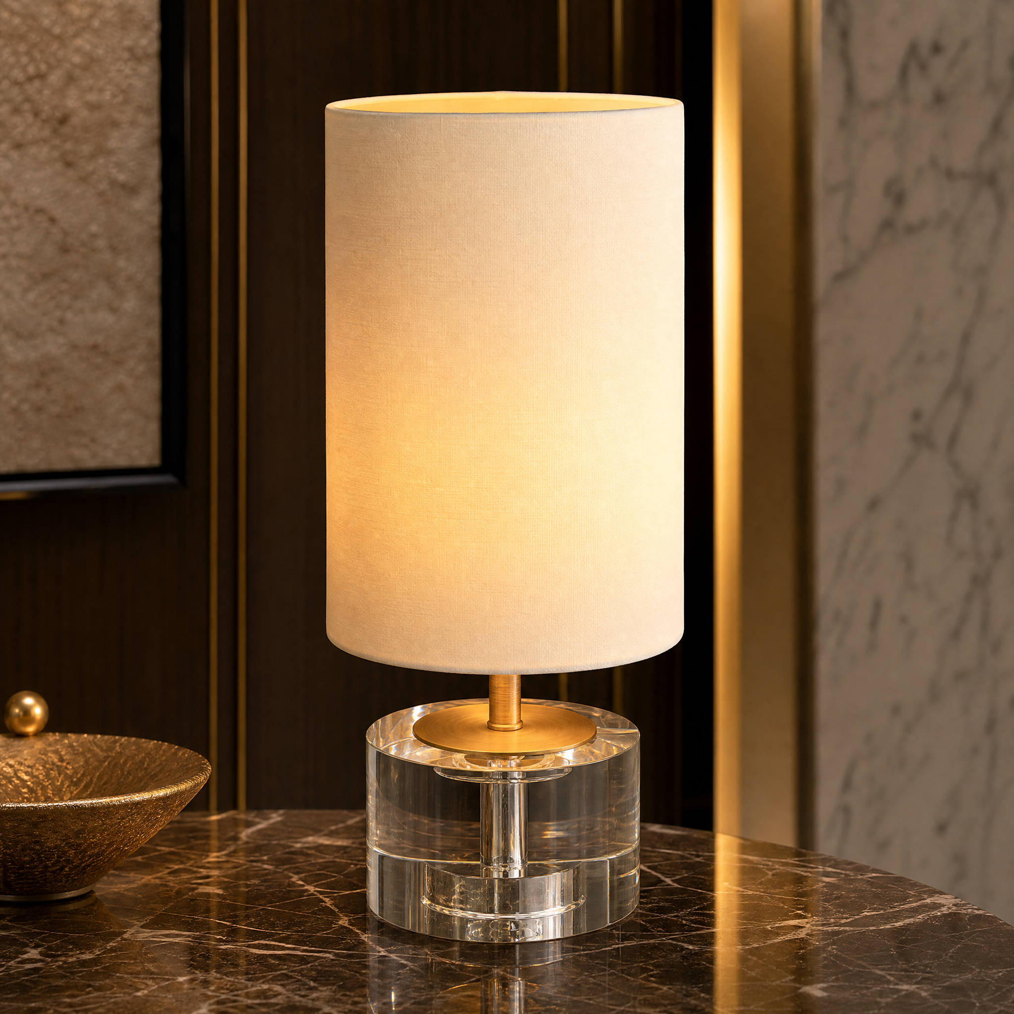 A detailed closeup of the VORELLI Alvoria lamp highlighting the solid clear crystal base and refined antique brass accent detailing.