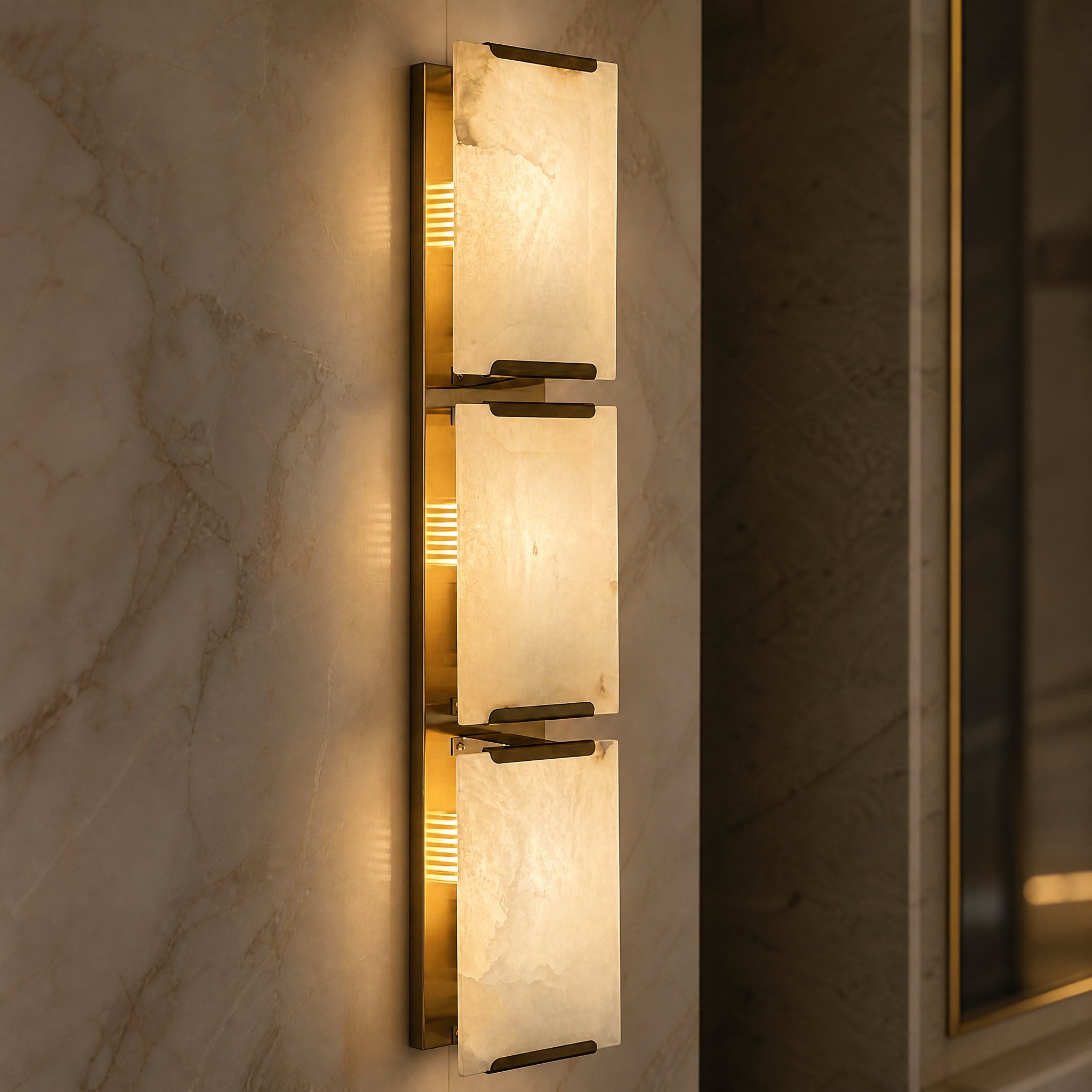 Close-up macro shot of the Angel Marble Wall Light II by VORELLI, showcasing the intricate texture of the layered marble and polished brass detailing.