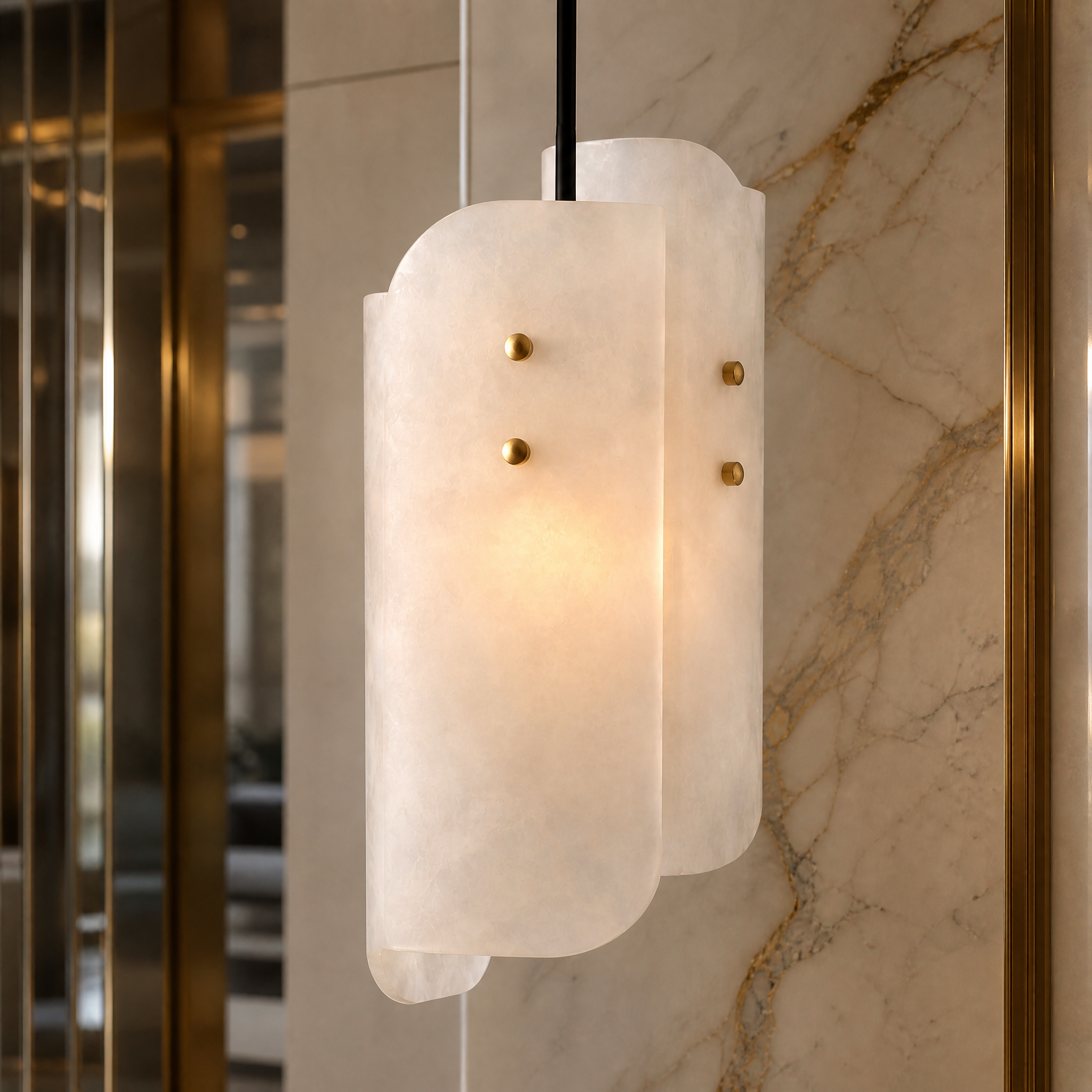 Detailed close-up of the VORELLI Antonio pendant light, highlighting the intricate natural veining and smooth, curved panels of the premium marble.