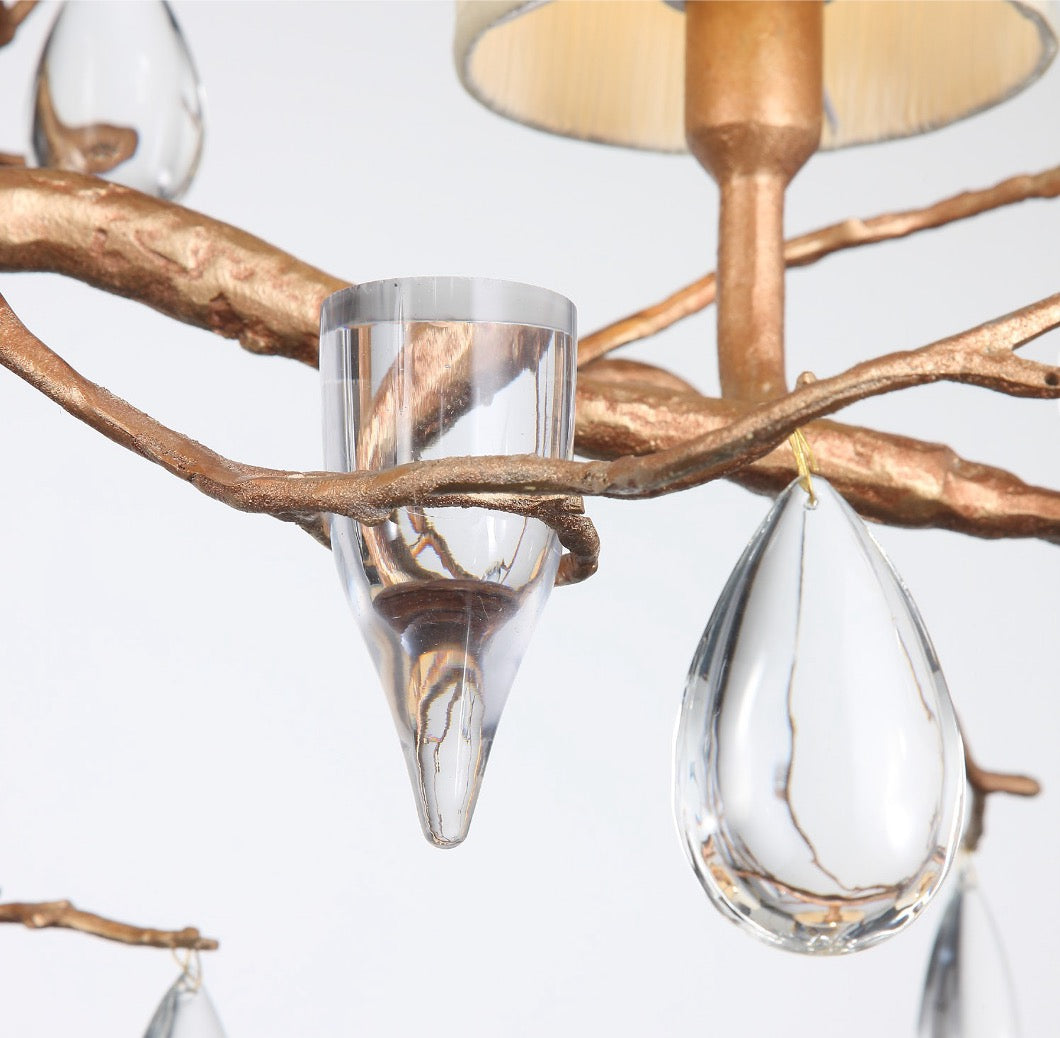 Close-up of crystal droplets hanging from shaded bulbs.