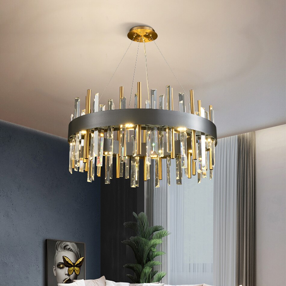 Warm chandelier glow enhancing a stylish blue-toned modern interior.