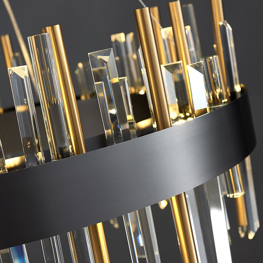 Detailed view of sleek gold tubing and layered crystal elements from side angle.