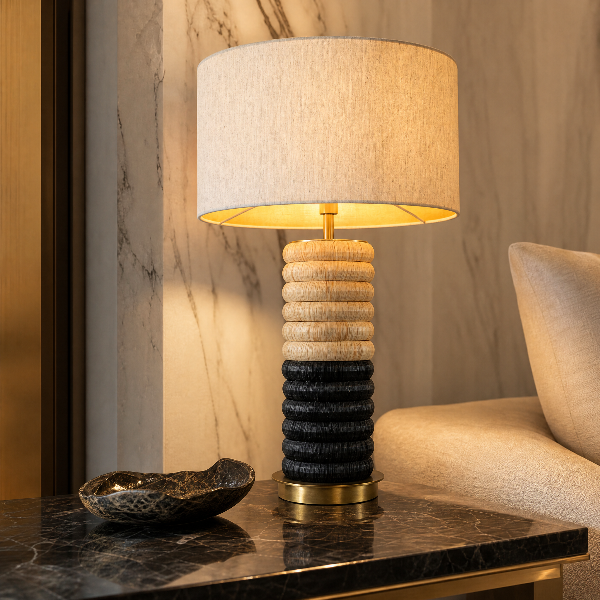 A detailed closeup of the VORELLI Arlivo table lamp, highlighting the textured stacked rings finished in contrasting antique brass and bold dark tones.