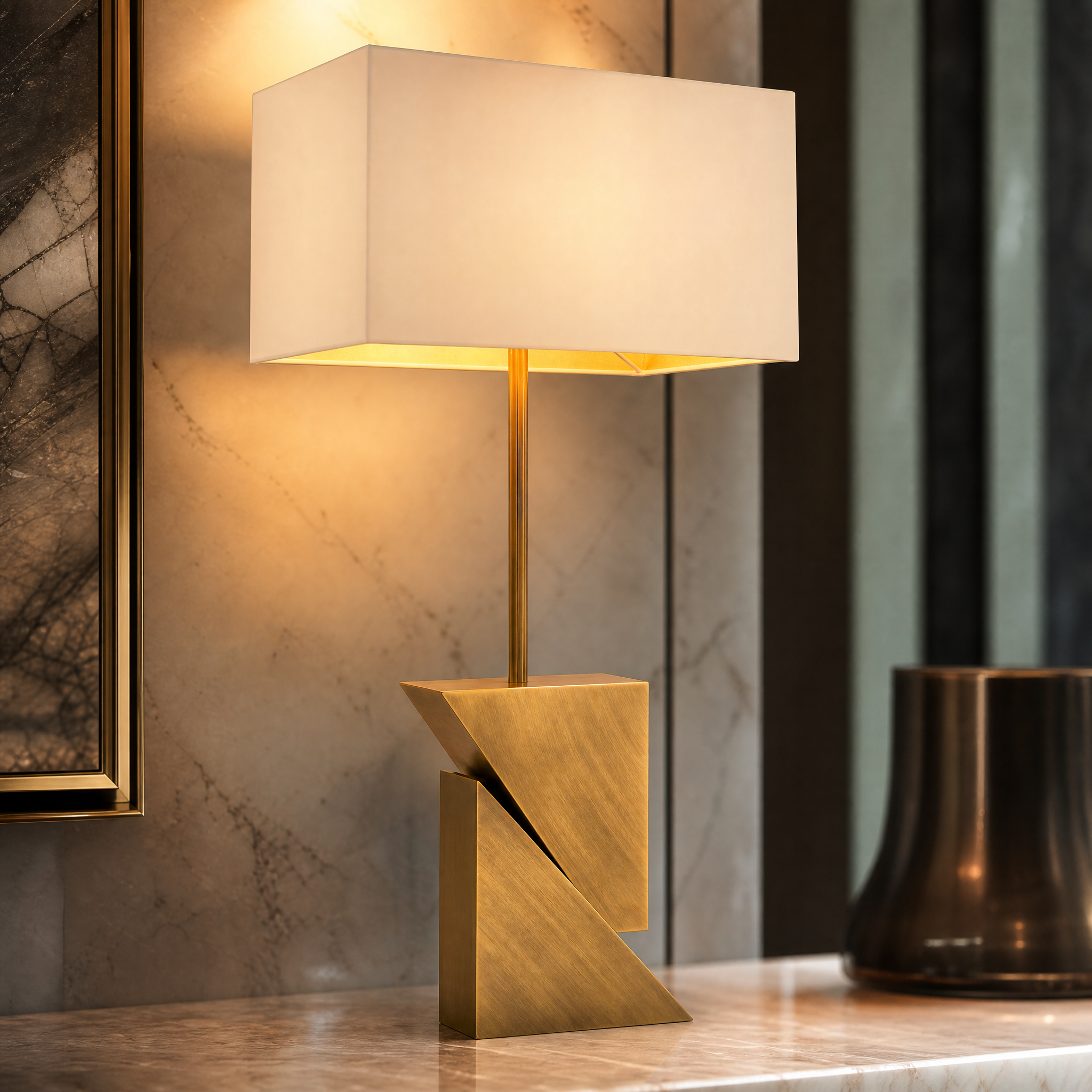 Close-up detail of the Arvanta table lamp showcasing its bold angular brass base and structured architectural silhouette.