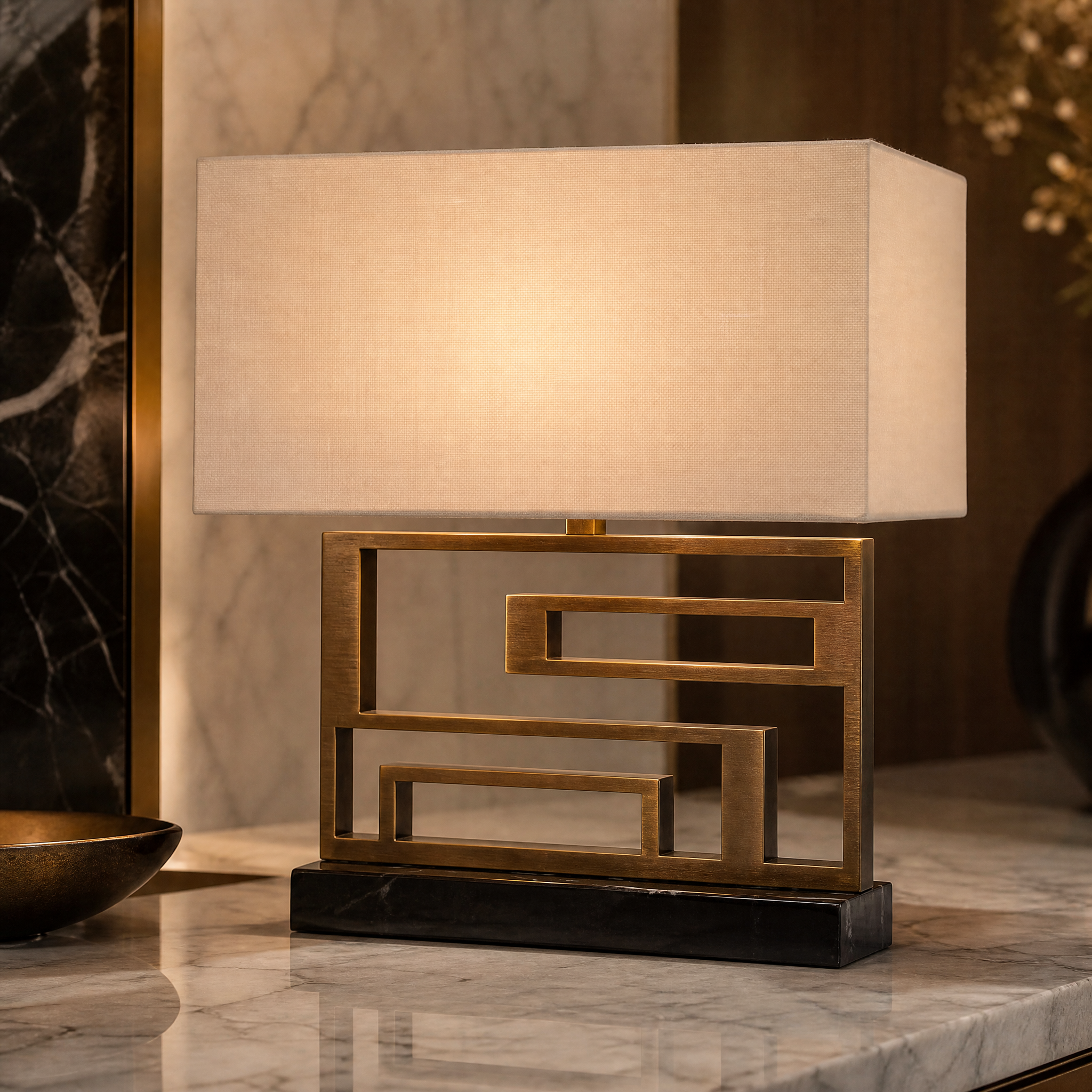A detailed closeup showcasing the bold geometric brass frame and sleek black marble base of the Arvanto table lamp.
