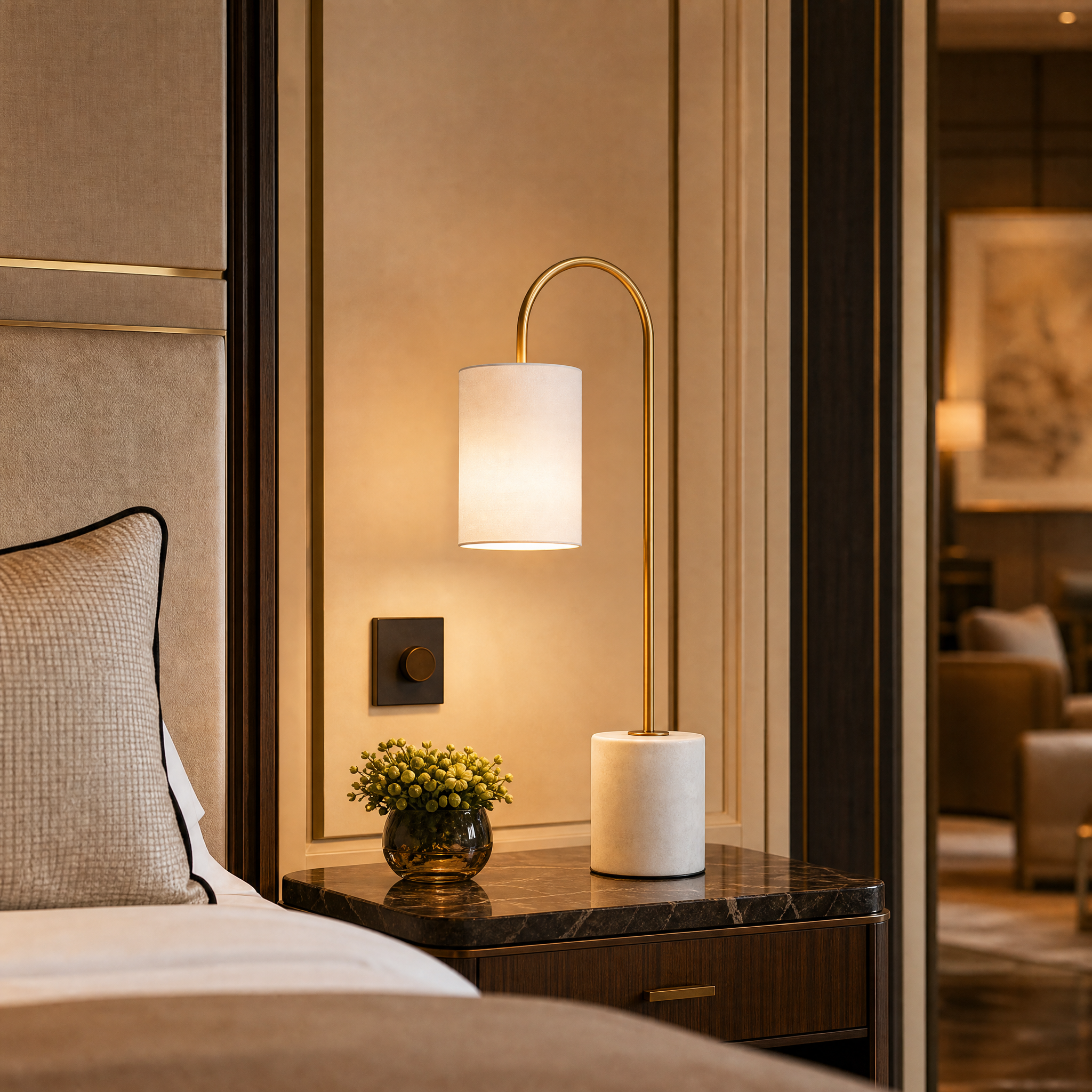 VORELLI Arvienne modern brass and white marble table lamps illuminating a luxury hotel lobby reception desk.