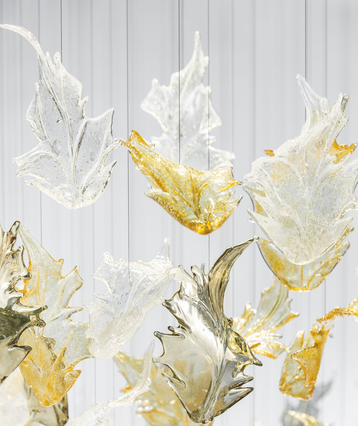 Atmospheric view of the Ember Leaf installation, emphasizing its warm amber tones and fluid movement within a high-end interior space.