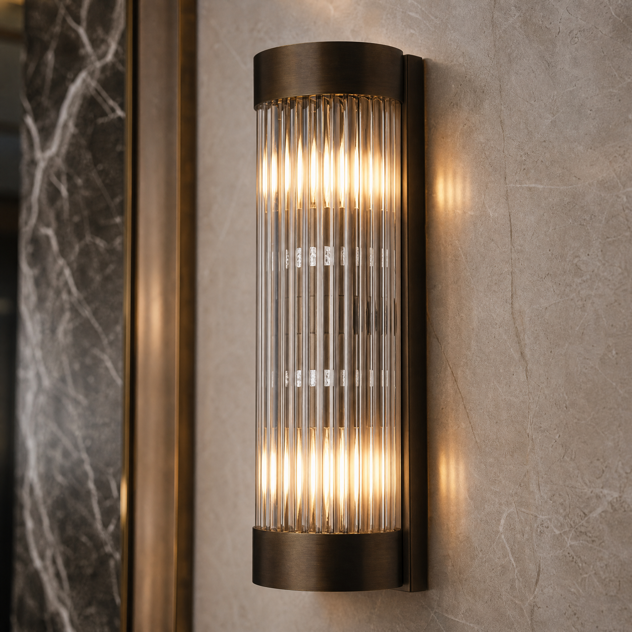 Close up detail of the Aurelio wall light featuring deep brass finish and vertical textured glass.