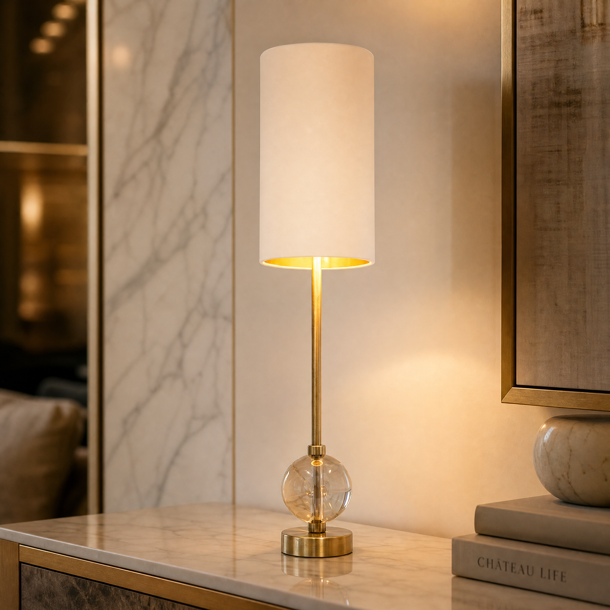 Macro shot of the Aurezza lamp showcasing the clear sculptural glass sphere base and polished warm brass accents.