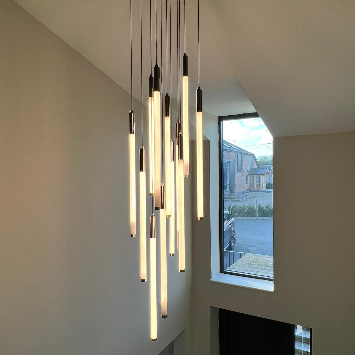 Contemporary hallway featuring the Avezzano chandelier with soft, warm light.