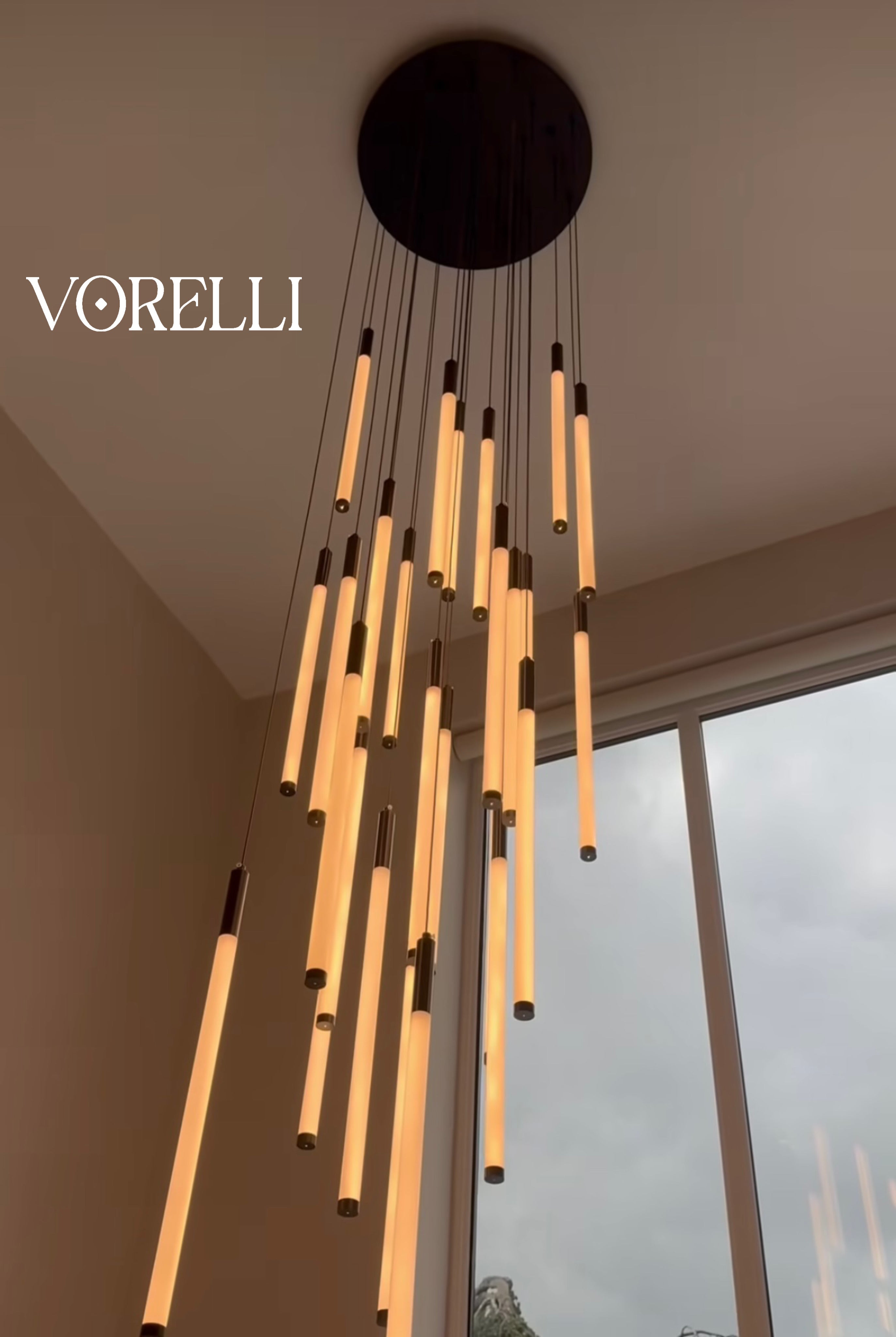 Close-up view of the pendant design on the Avezzano chandelier against a curved wall.