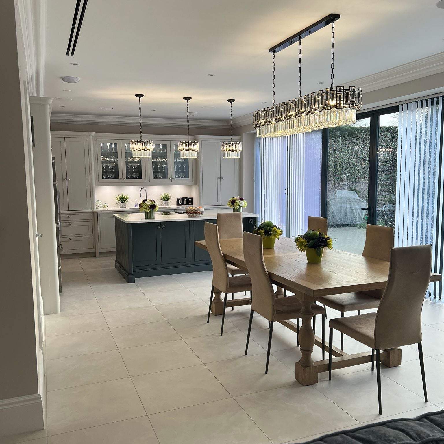 Belvedere rectangular chandelier installed above a luxury kitchen island with crystal detailing and refined ambient lighting