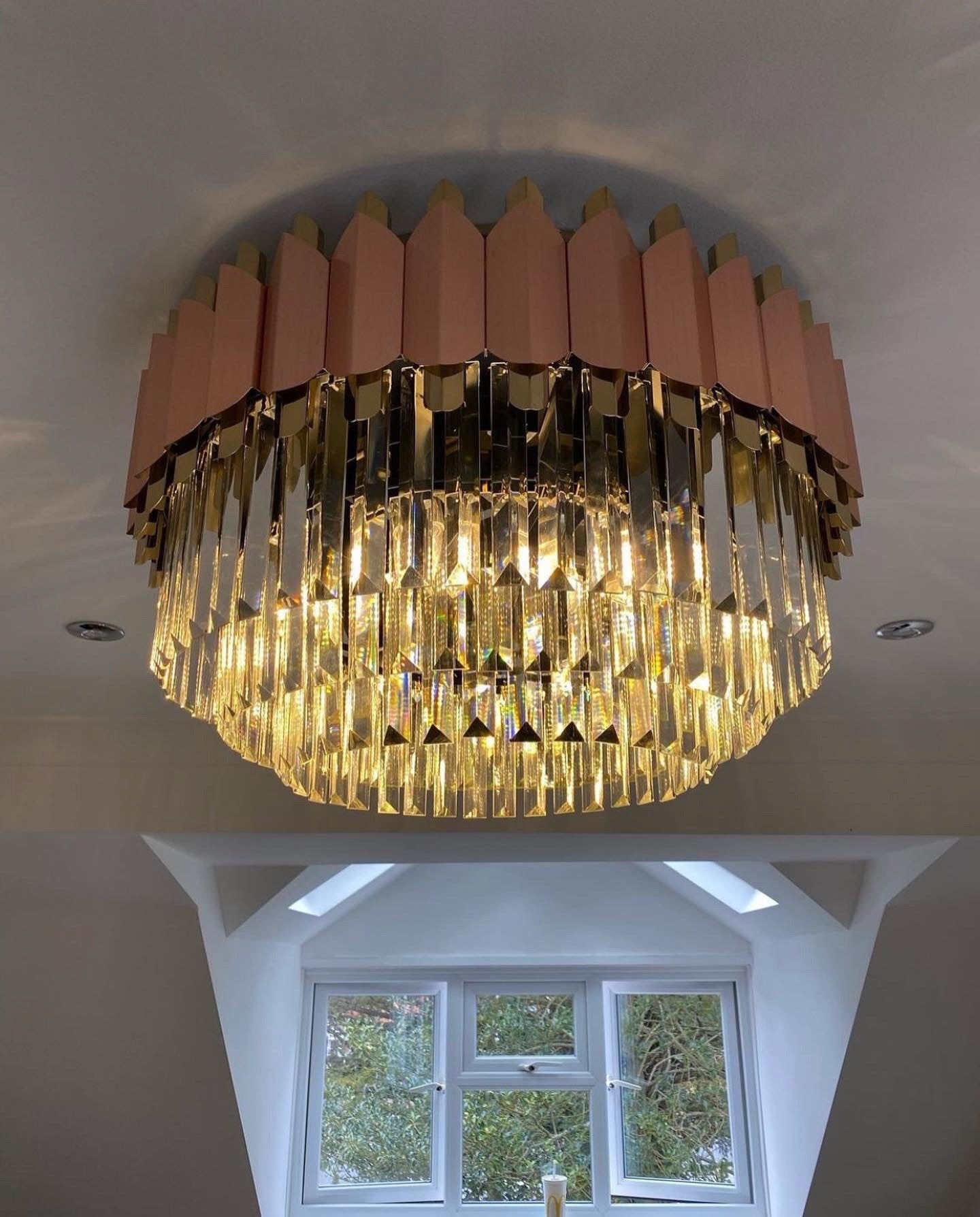 Bianca circular chandelier with layered crystal prisms creating warm ambient luxury lighting