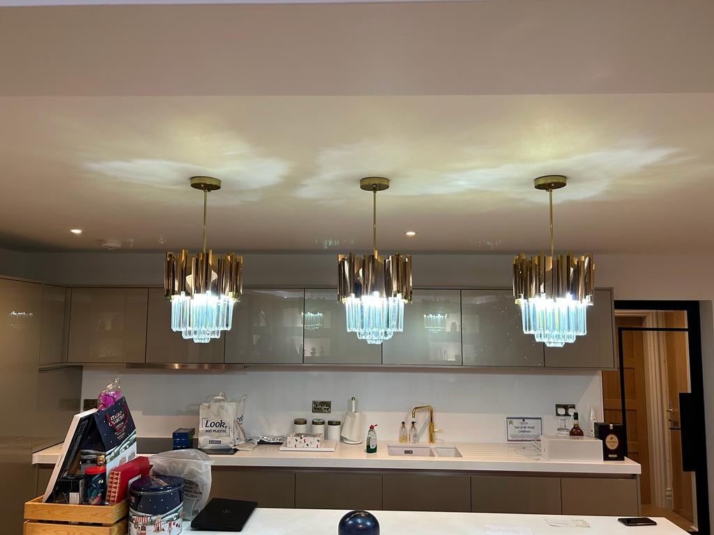 Designer Boeotia pendant light featuring faceted crystal bars above a luxury kitchen island