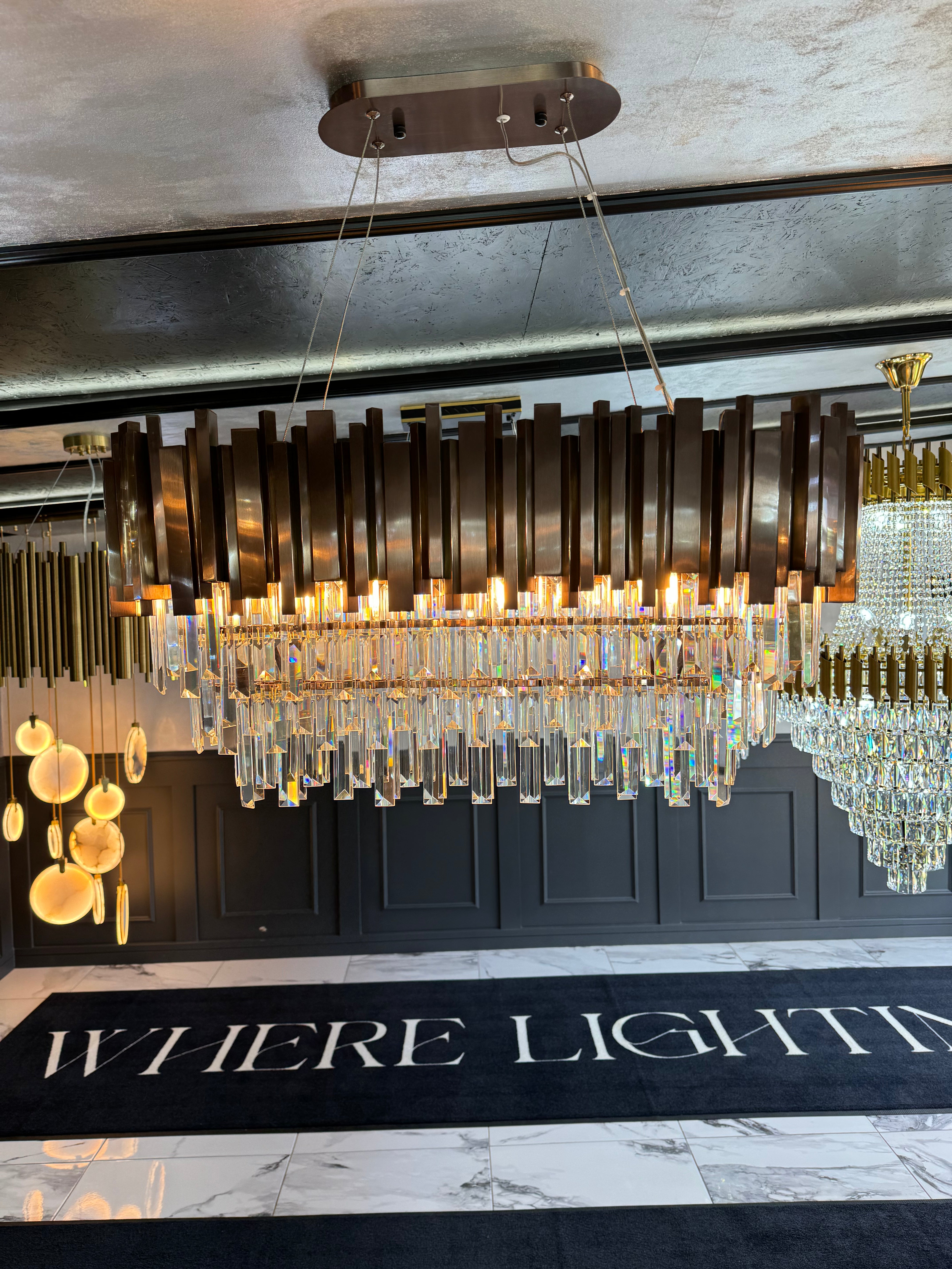 Boeotia rectangular chandelier with diamond cut crystal prisms displayed in a luxury lighting showroom