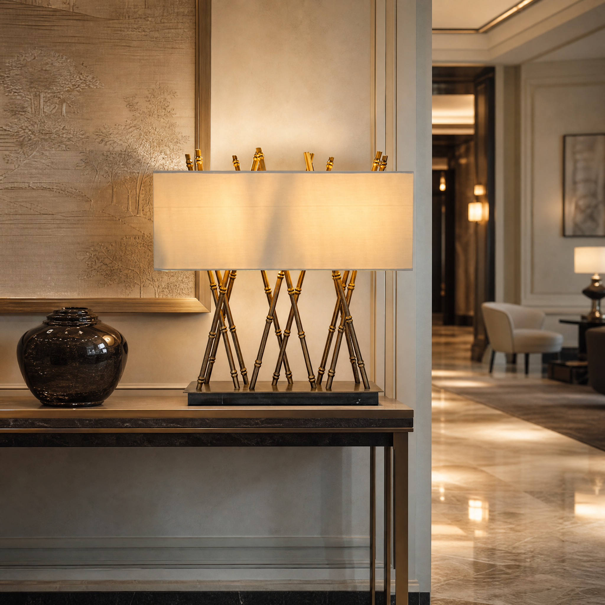 Architectural brass table lamp placed on a hotel bedside table casting warm ambient glow