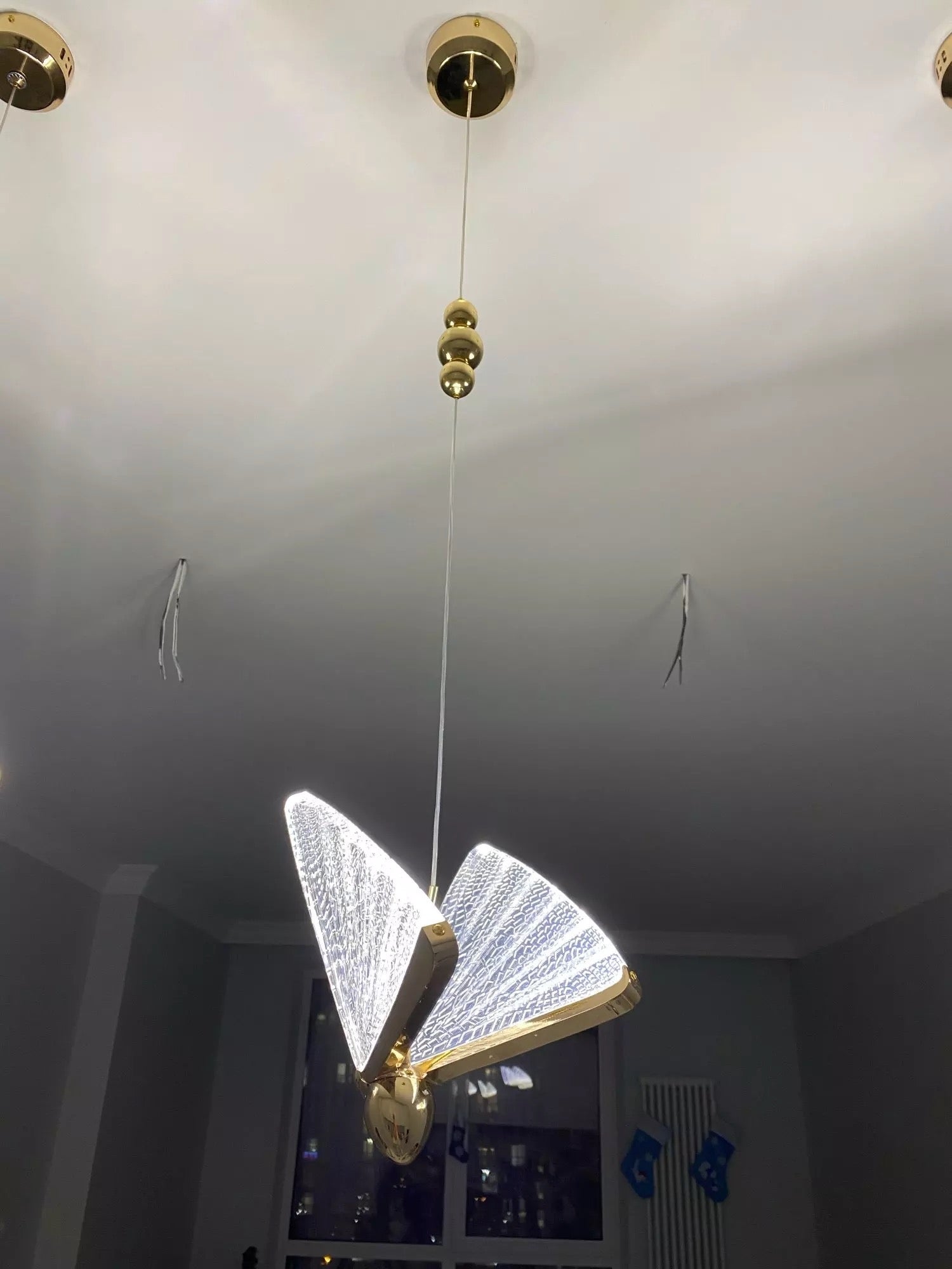 Close-up of illuminated butterfly crystal pendant light detail