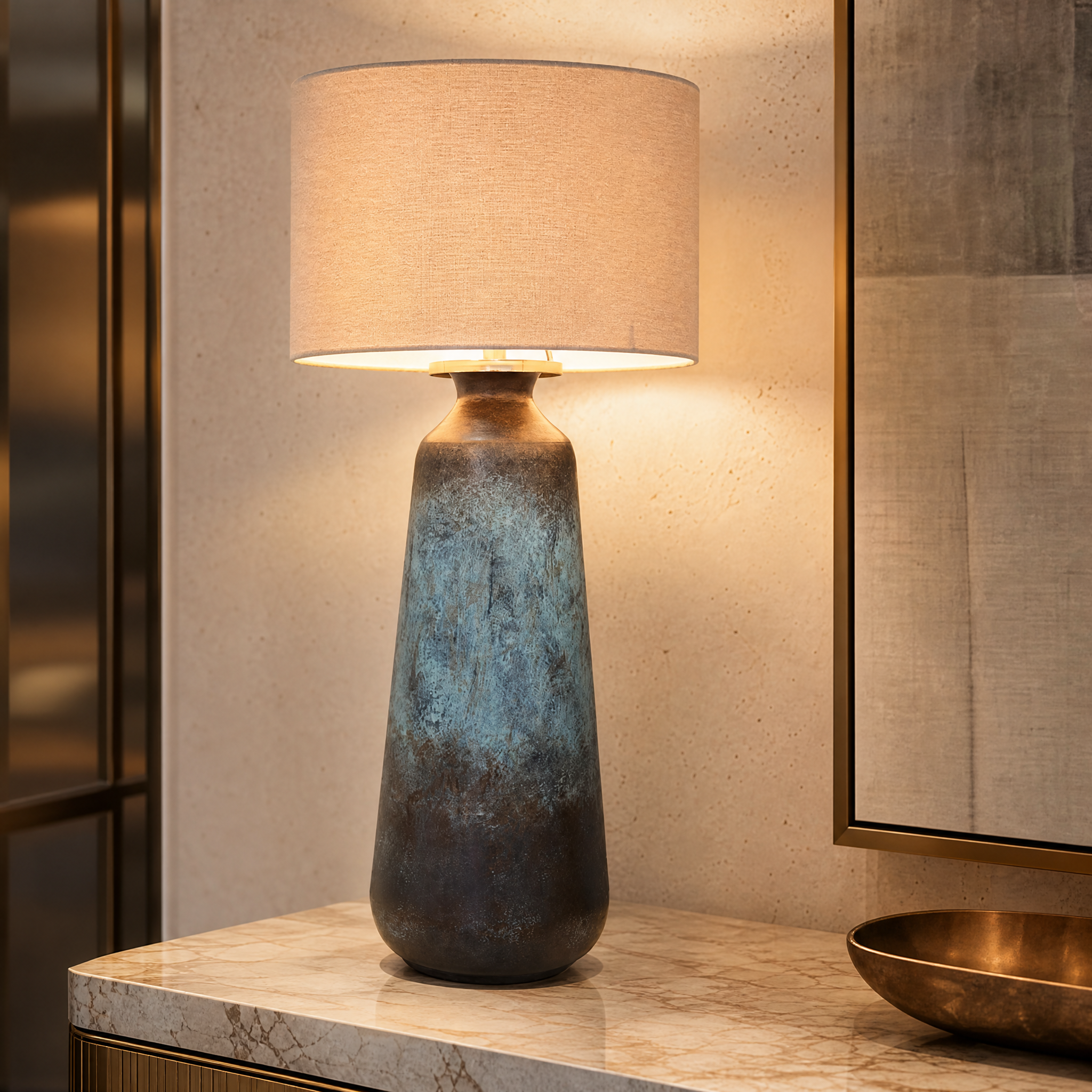 A detailed close-up shot showing the intricate texture and rich, layered blue and bronze tones of the VORELLI Caldera table lamp base.