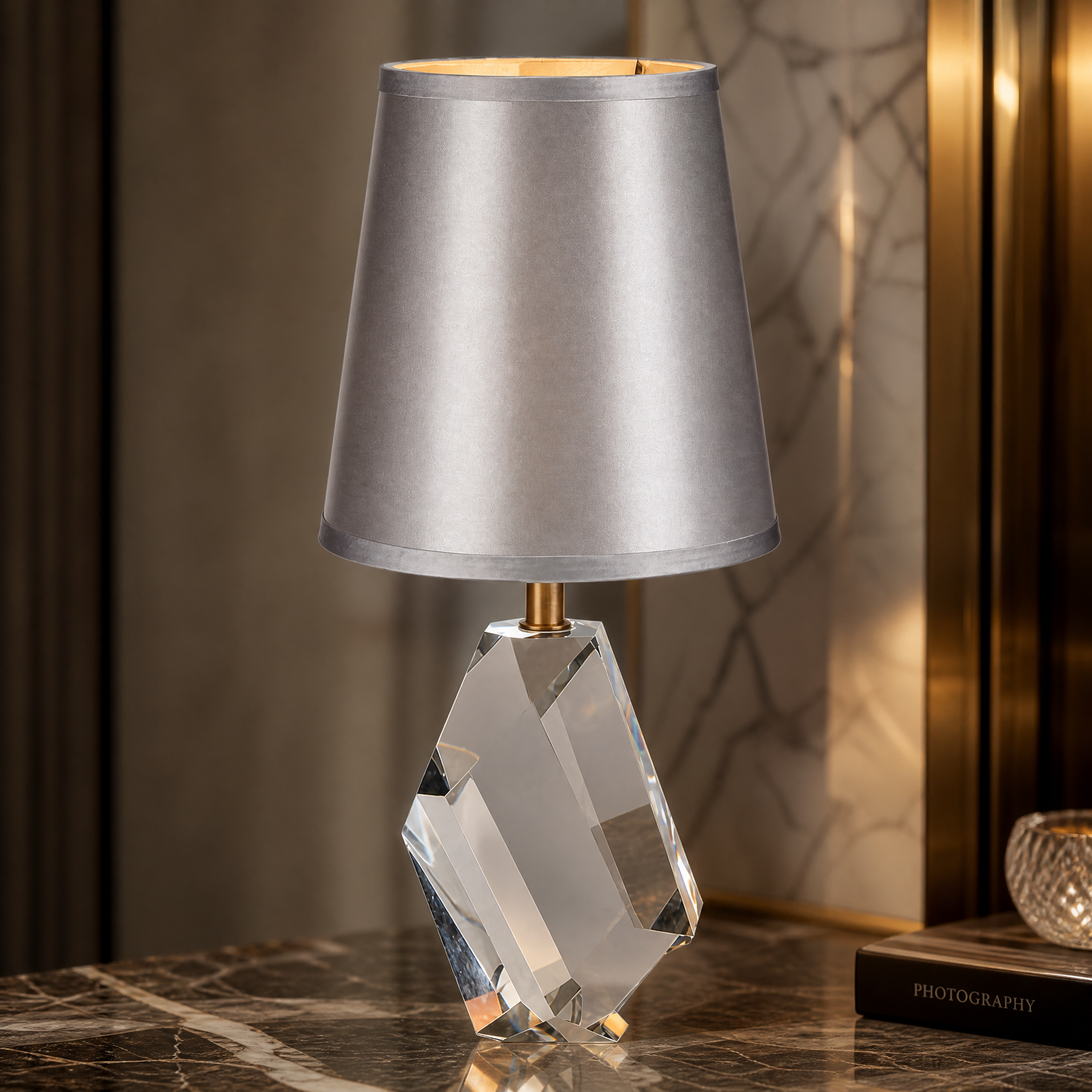 Close-up of the sculpted faceted crystal base and antique brass detailing of the Caldria Table Lamp