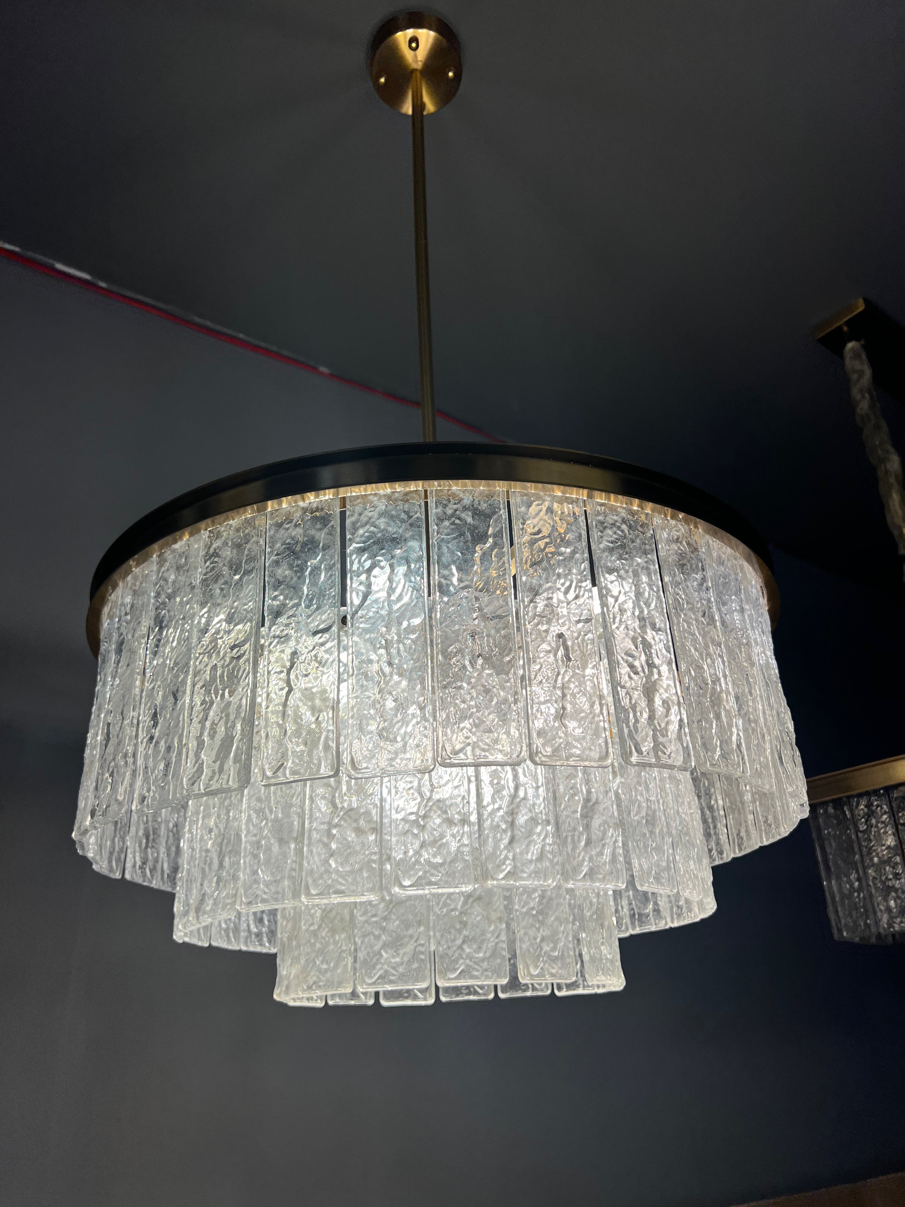 Cellini circular chandelier installed in an upscale interior showcasing dramatic multi-tier crystal lighting design