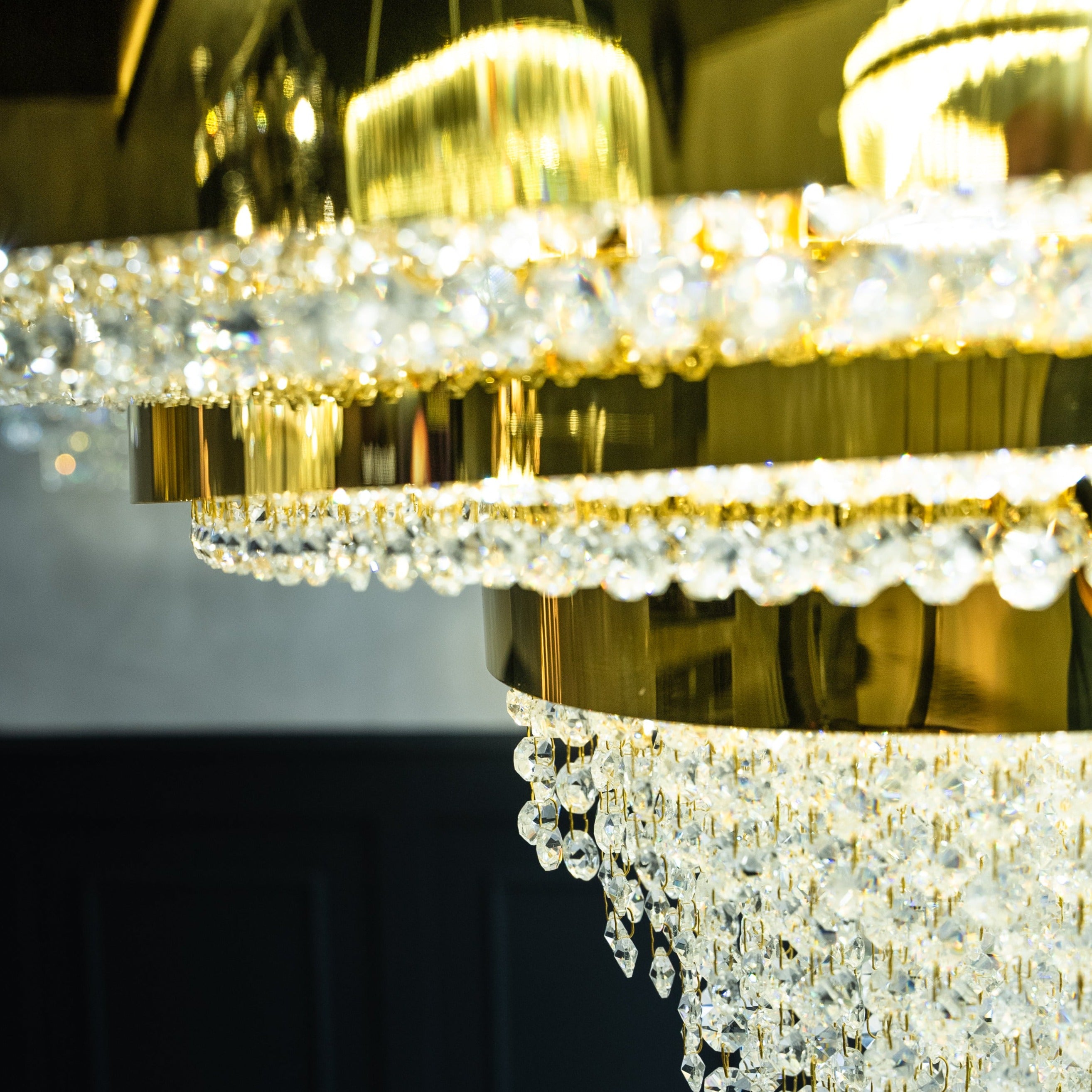 Designer circular chandelier casting warm ambient light across a sophisticated luxury living space