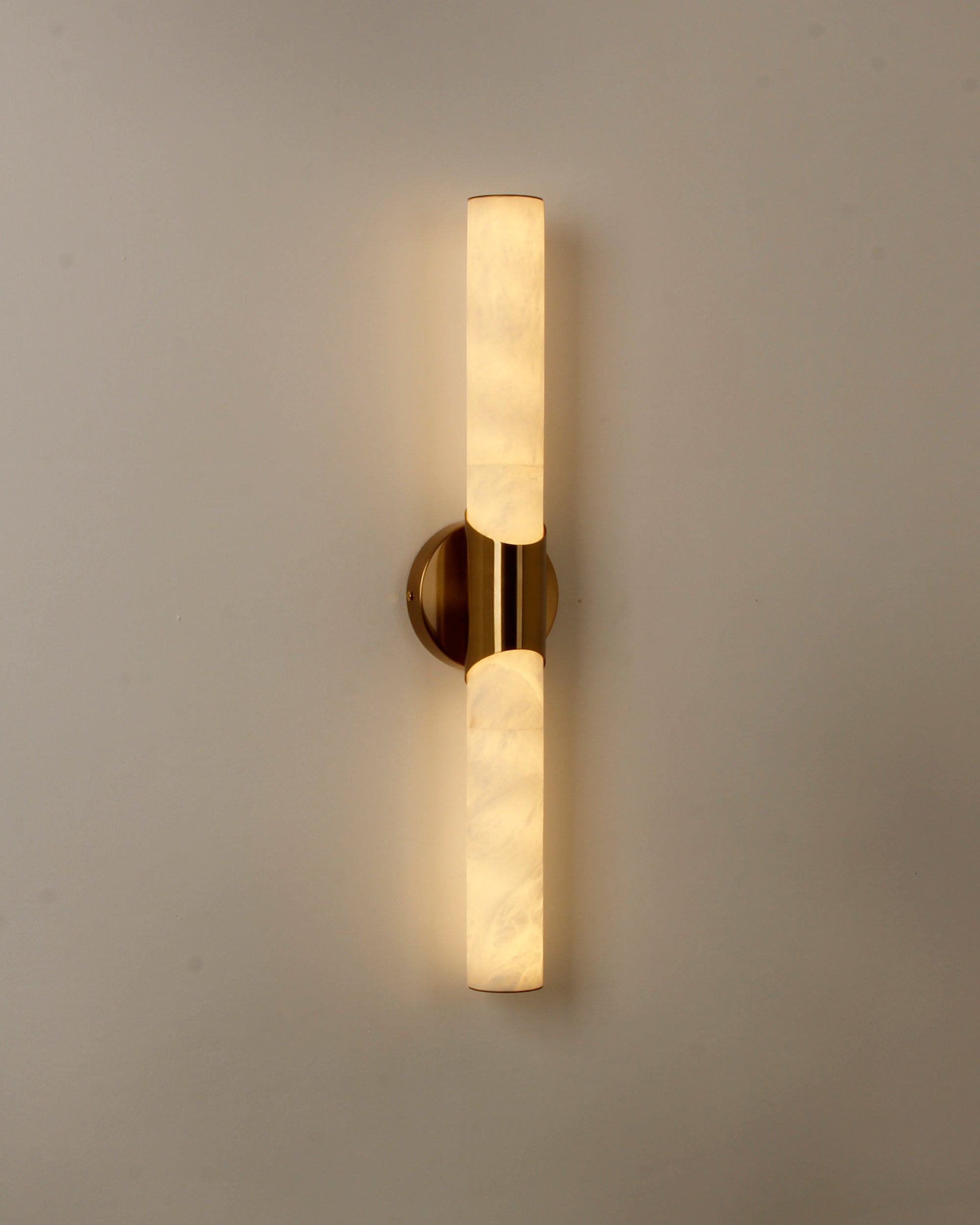 cilindro marble wall light front view showing soft ambient glow