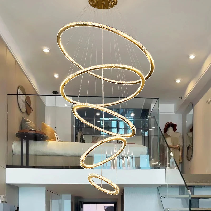 claremont ring chandelier suspended over open staircase with glowing spiral rings