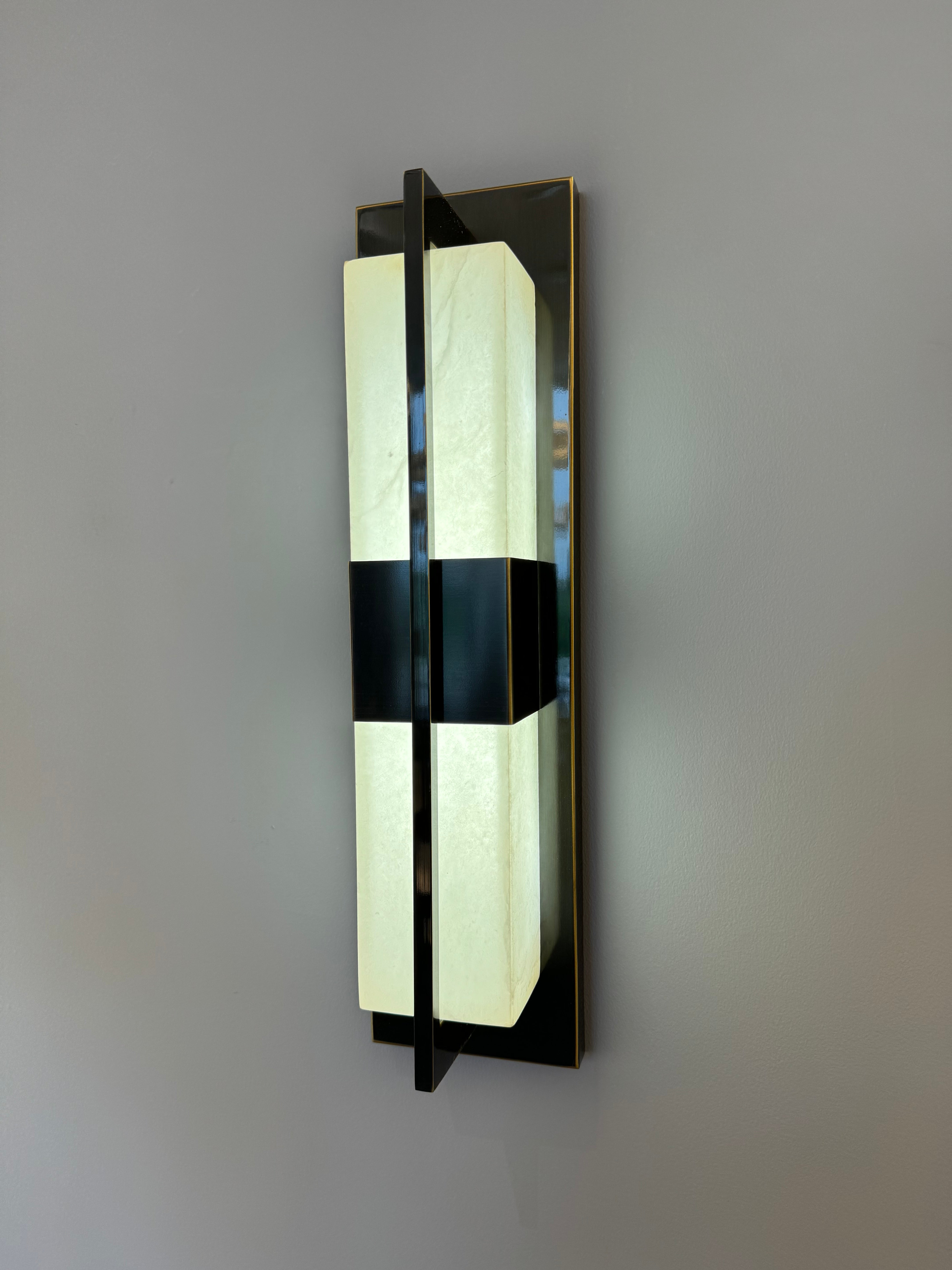 illuminated classisco marble wall light viewed from side angle