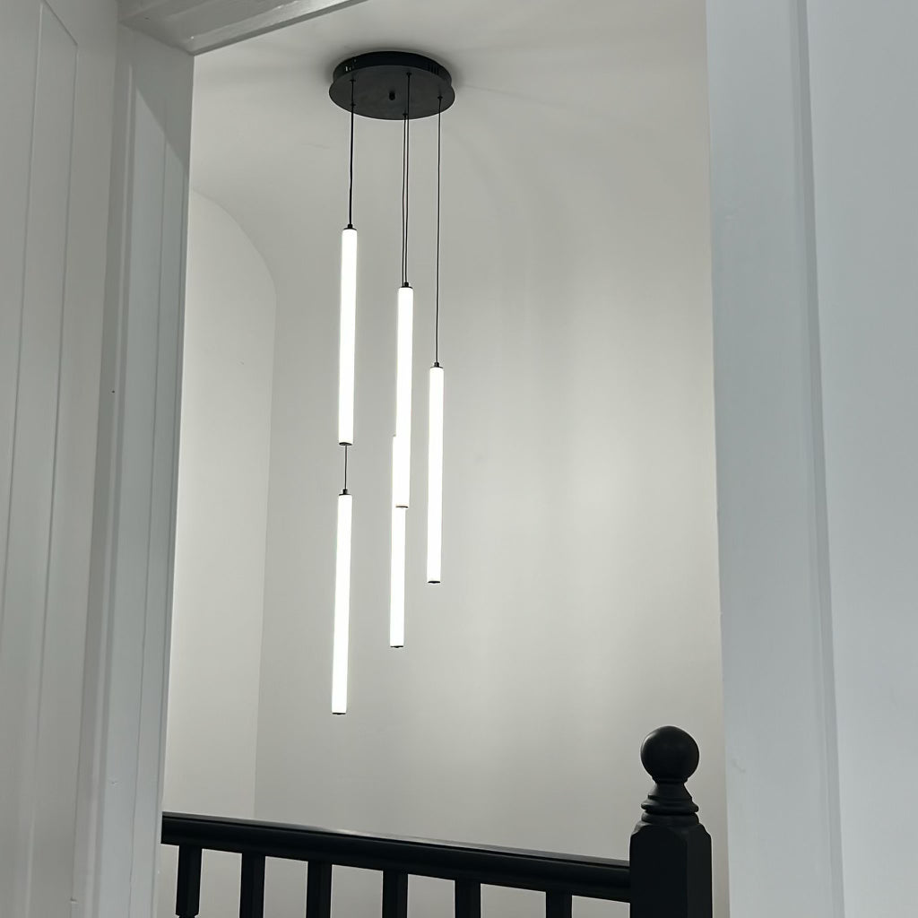 cowley pendant chandelier installation with multiple tubes in modern hallway space