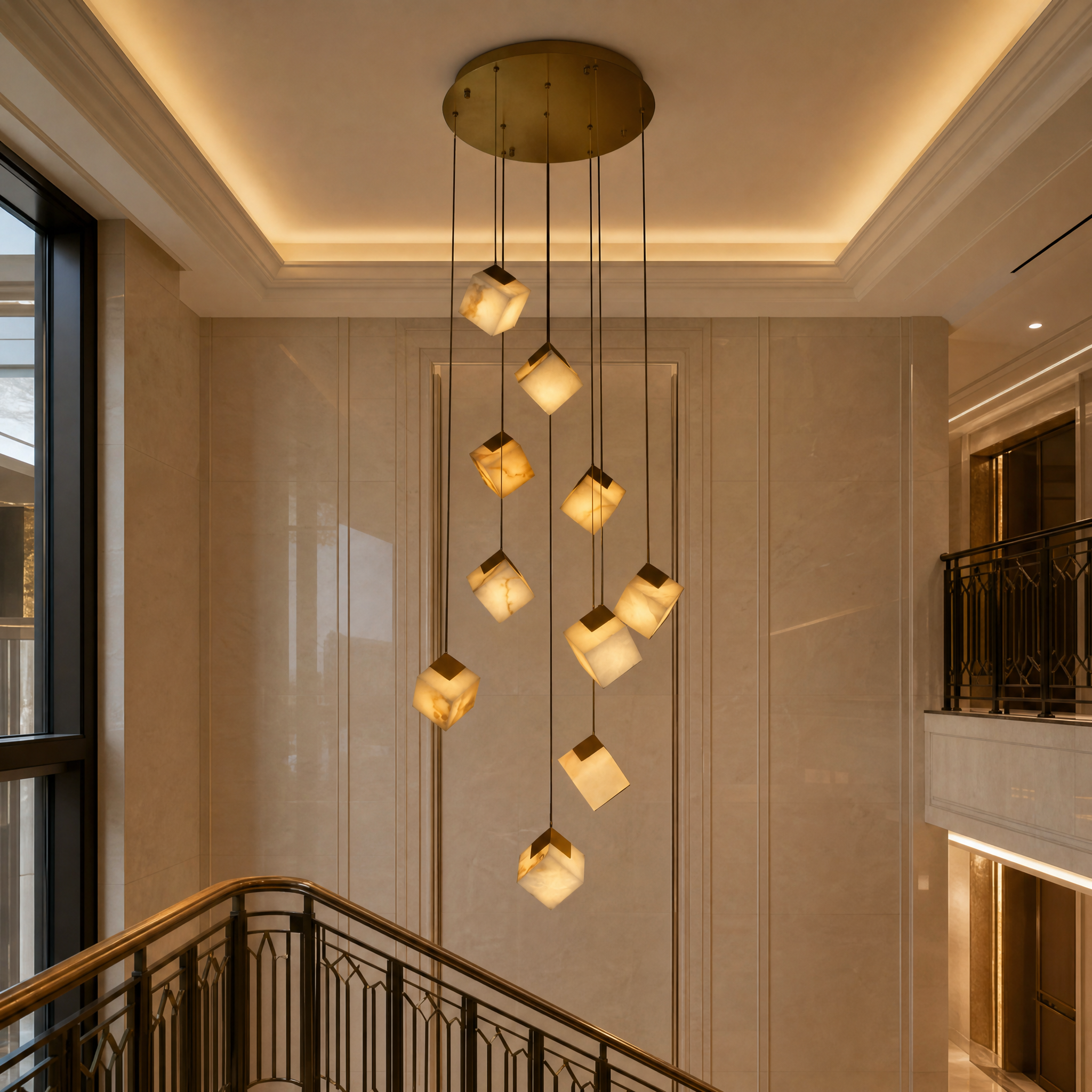 Grand double-height hospitality lobby featuring the VORELLI Cube Marble Pendant Staircase Chandelier casting a warm ambient glow.
