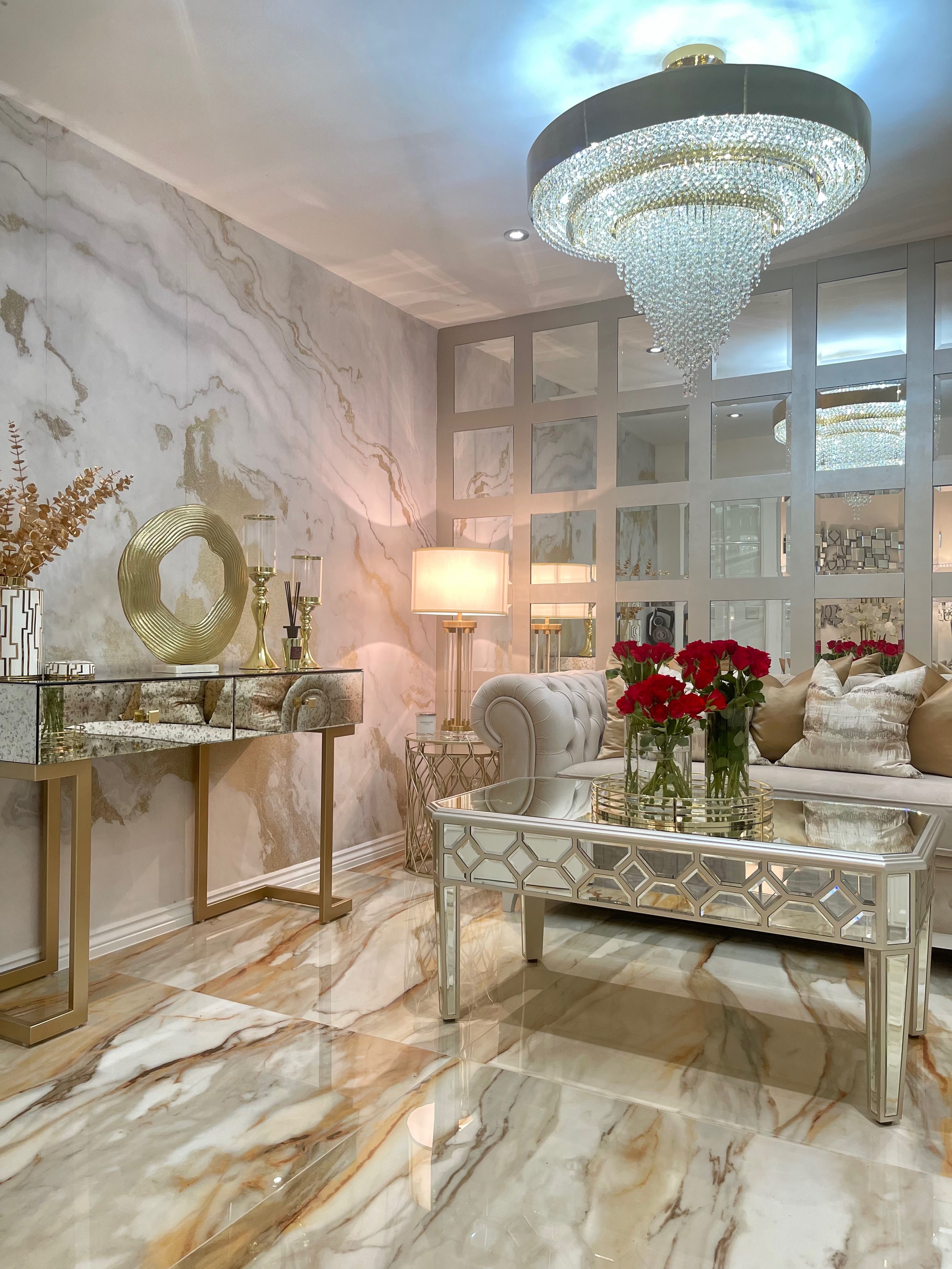 Designer circular chandelier casting warm ambient light across a sophisticated luxury living space