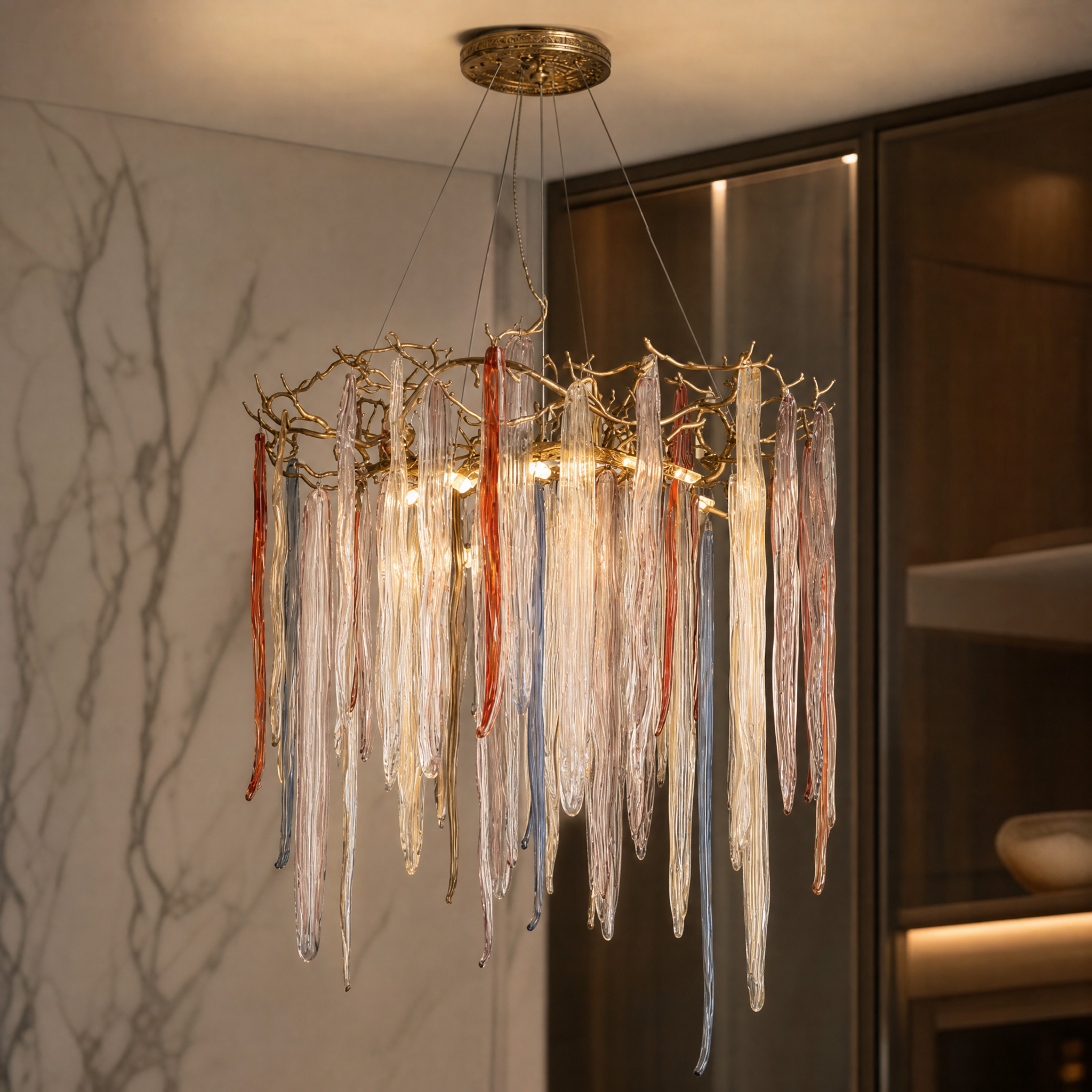 Close-up of hand-formed glass icicles on the VORELLI circular chandelier showcasing intricate textures and depth.