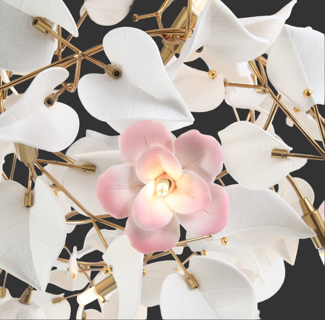 Detailed close-up of the VORELLI Fiorella Chandelier's intricate craftsmanship, capturing the soft lighting reflecting off the white sculptural leaves.