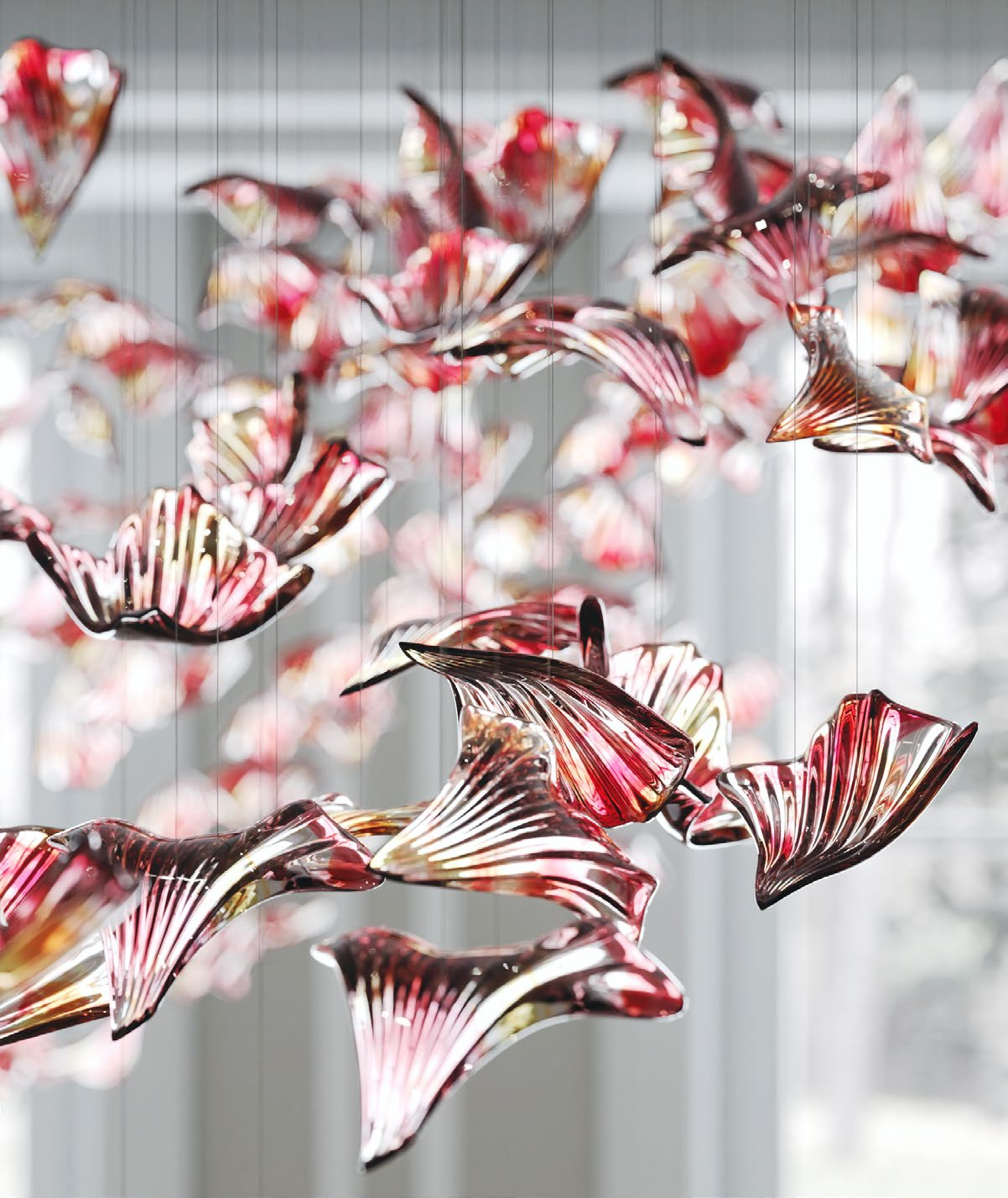 Detailed view of the amber tones and soft organic rhythm of the drifting glass elements within the VORELLI installation.